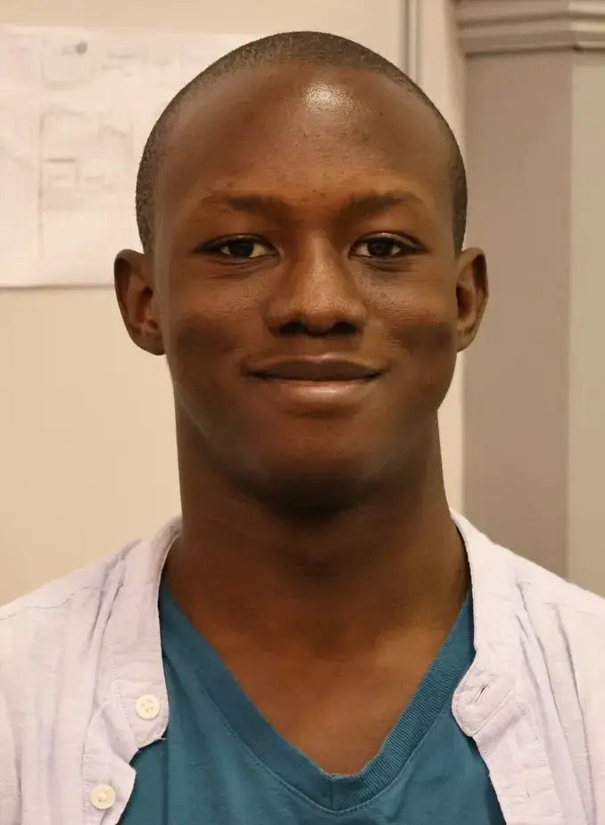 Male student wearing white and blue shirt