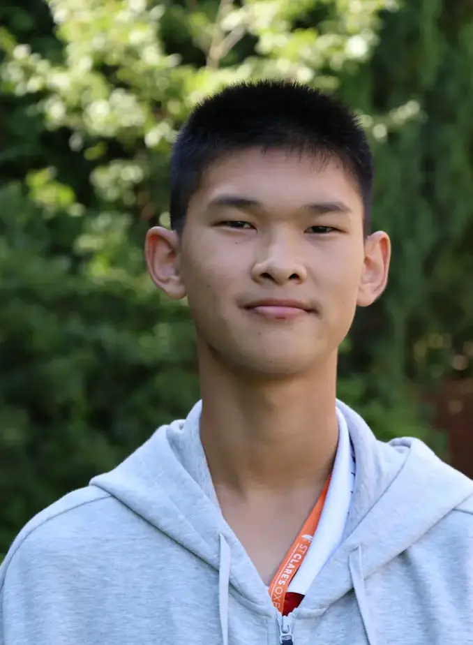 Male student wearing white shirt in garden