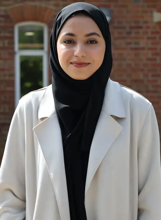 Female student wearing a black hijab and a white blazer