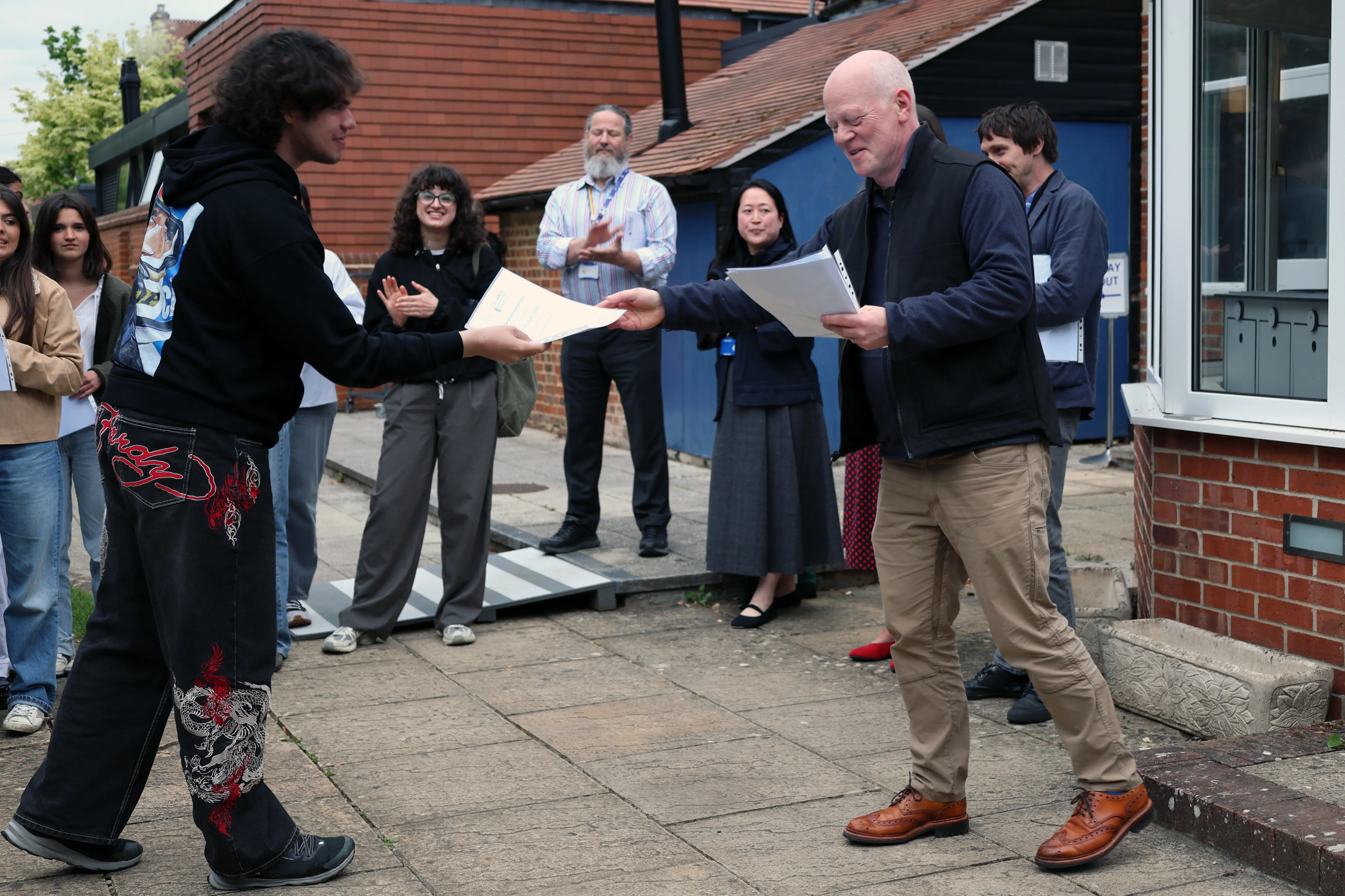 University Foundation student receiving their graduation certificate