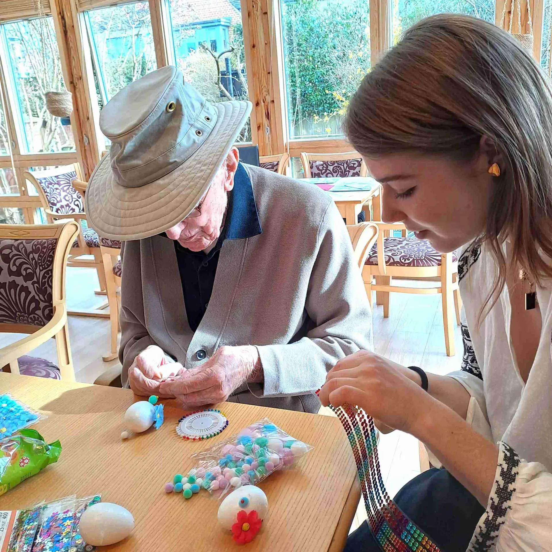 Student and older man doing craft activity together