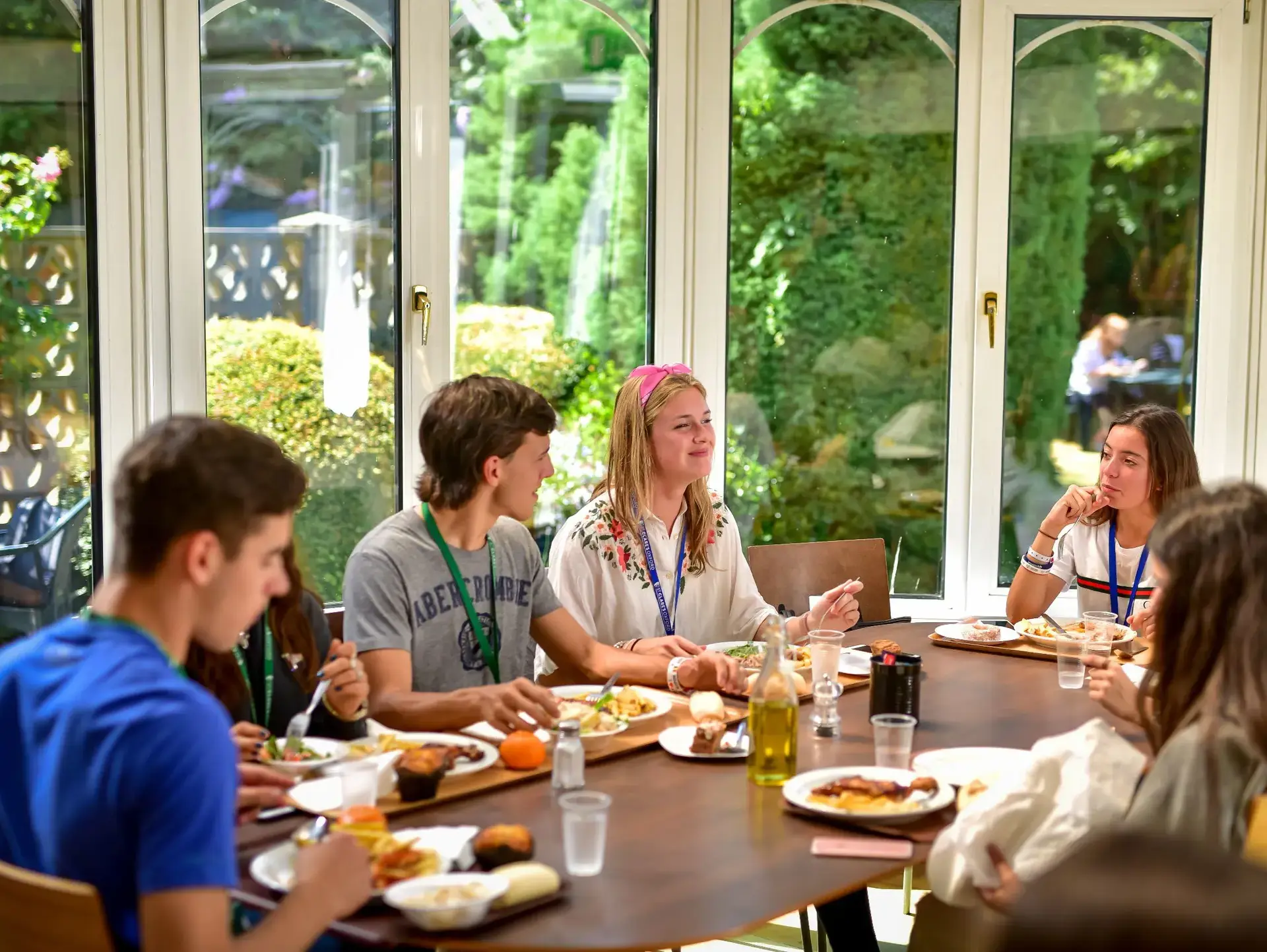 Students eating together in well-lit dining room