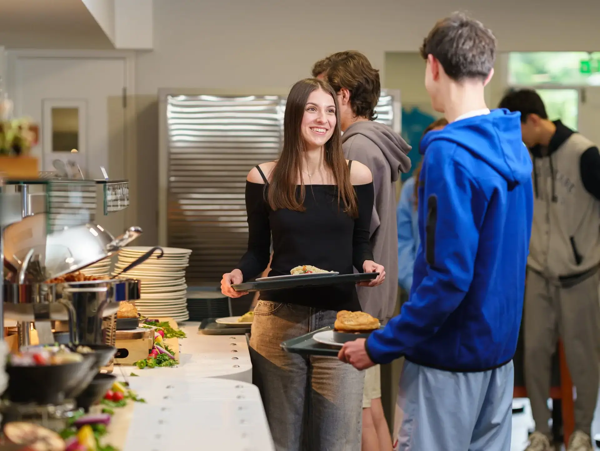 Students collecting food from kitchen