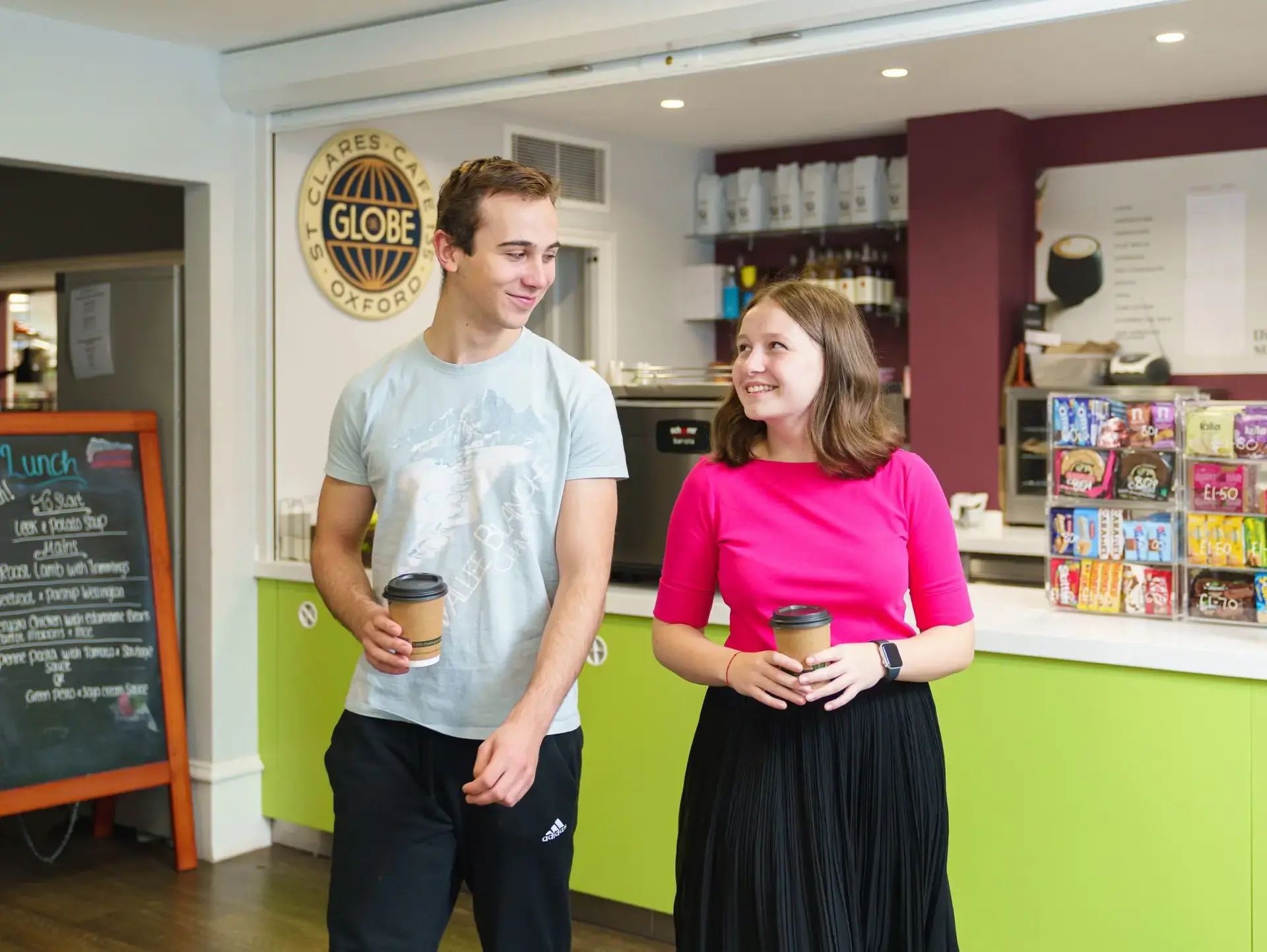 Two students collecting takeaway coffee