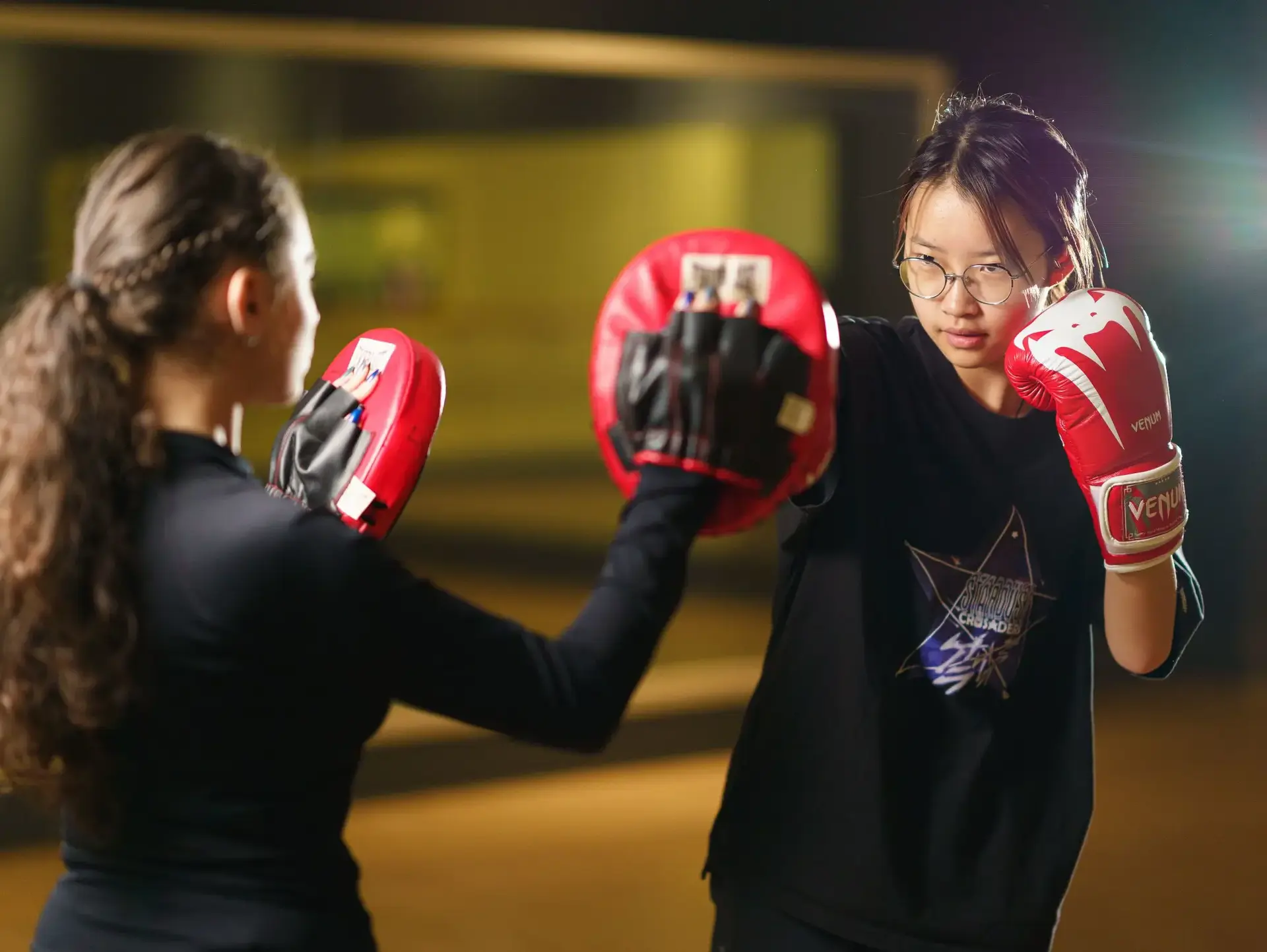 Student boxing with pads