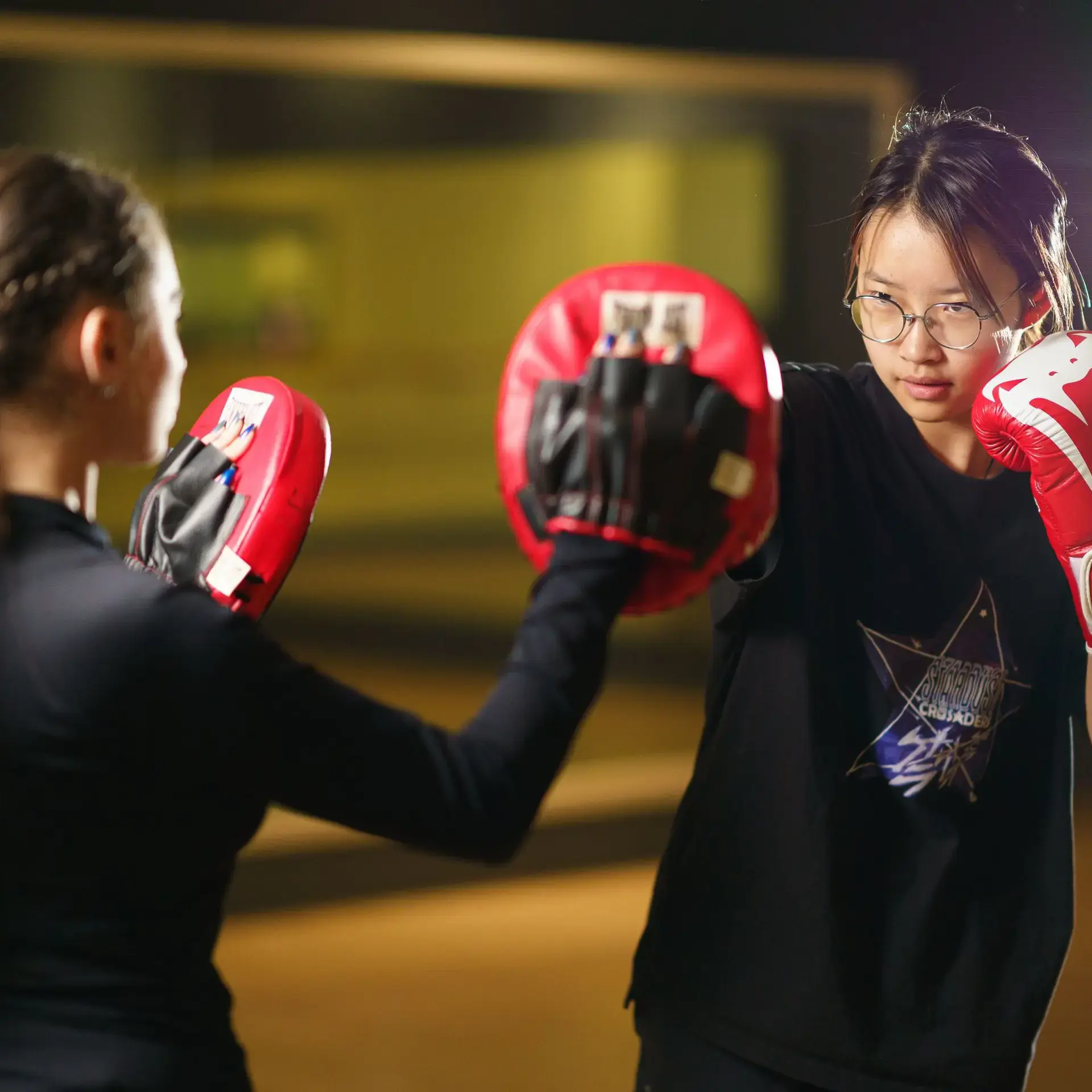 Student boxing with pads