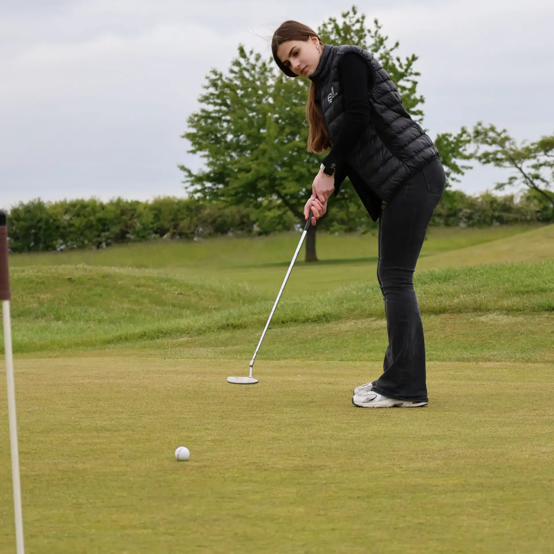 Student playing golf