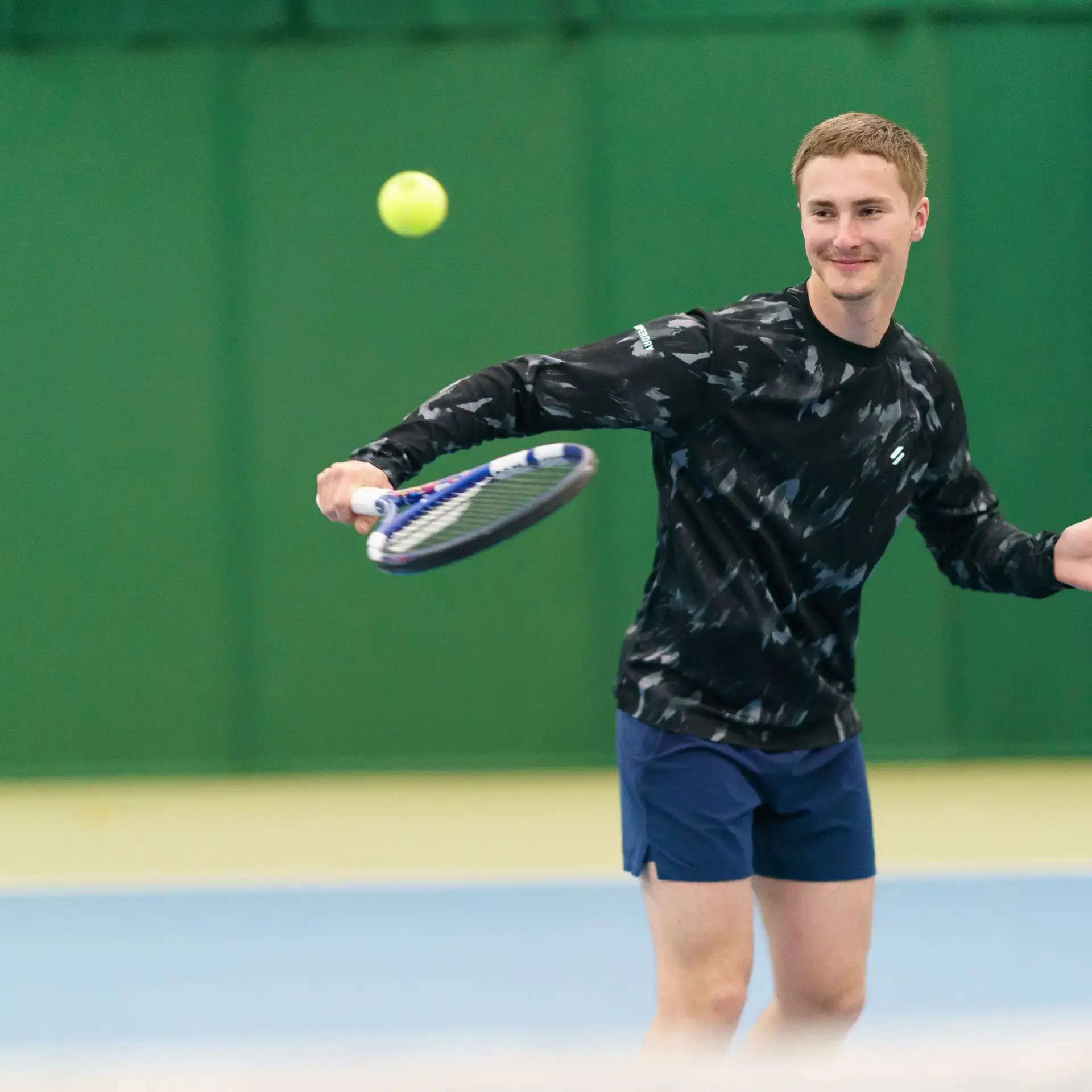 Student playing tennis