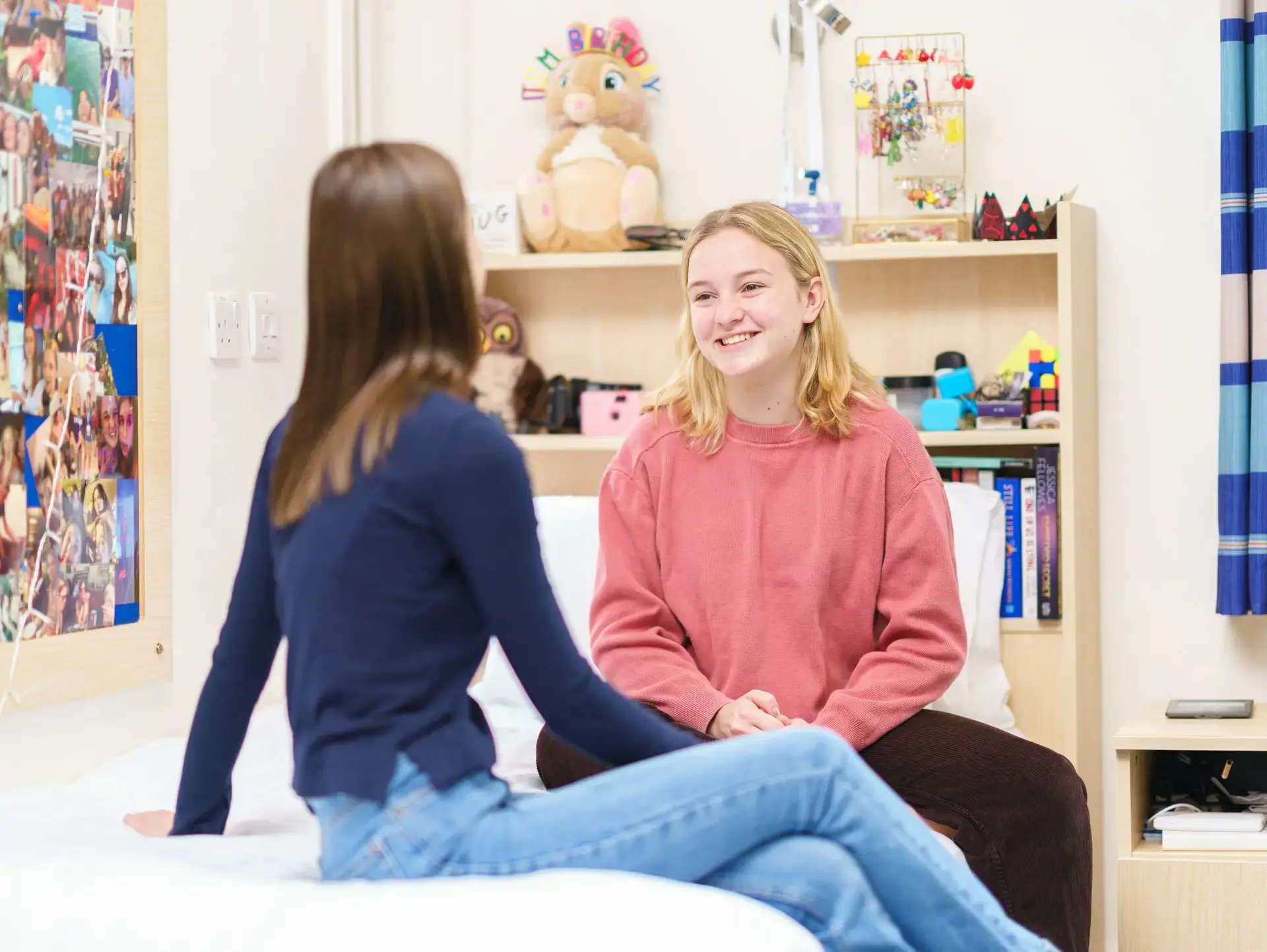 Two students sitting in their accommodation room having a conversation