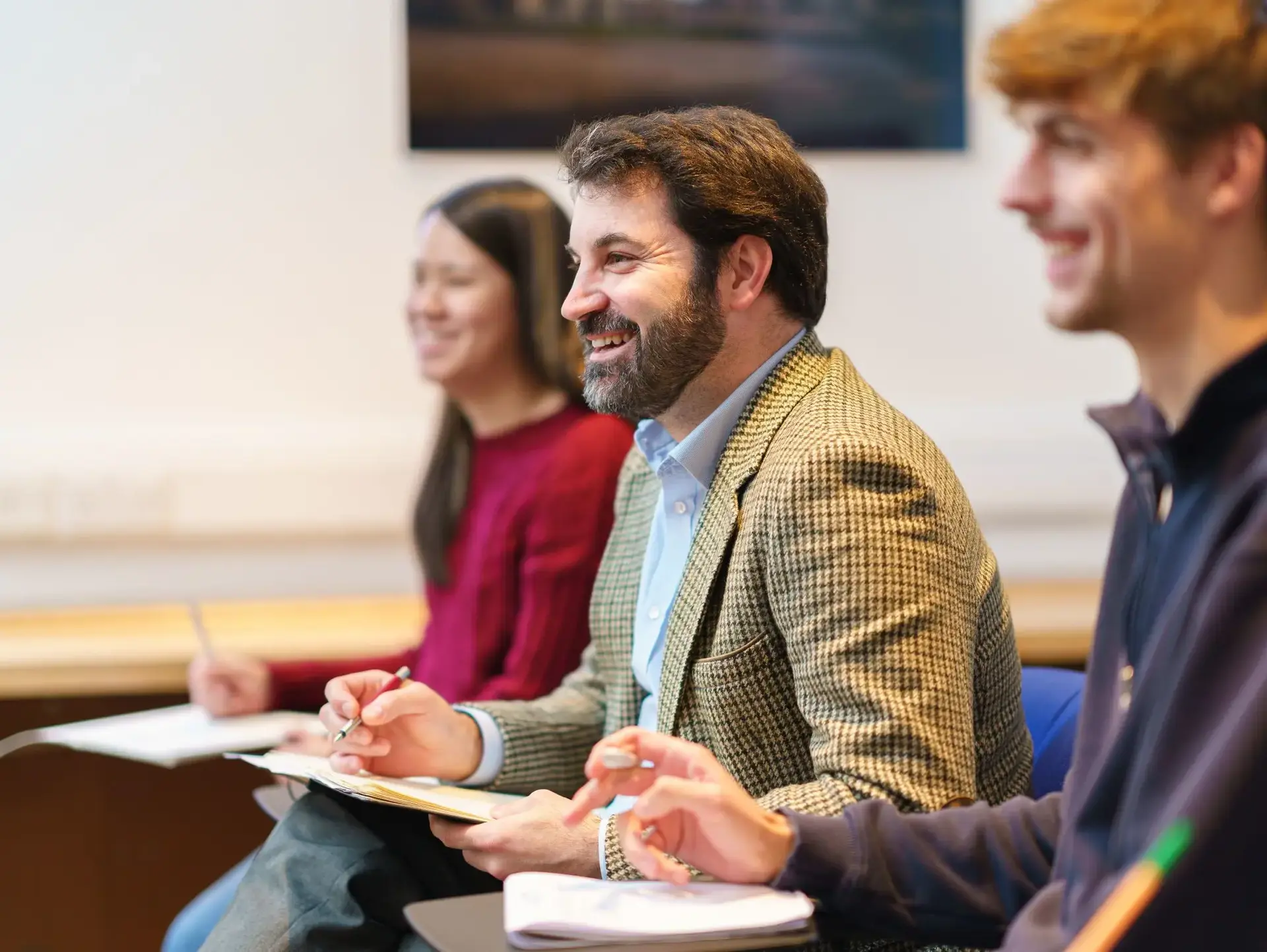Teachers smiling up from their work during seminar