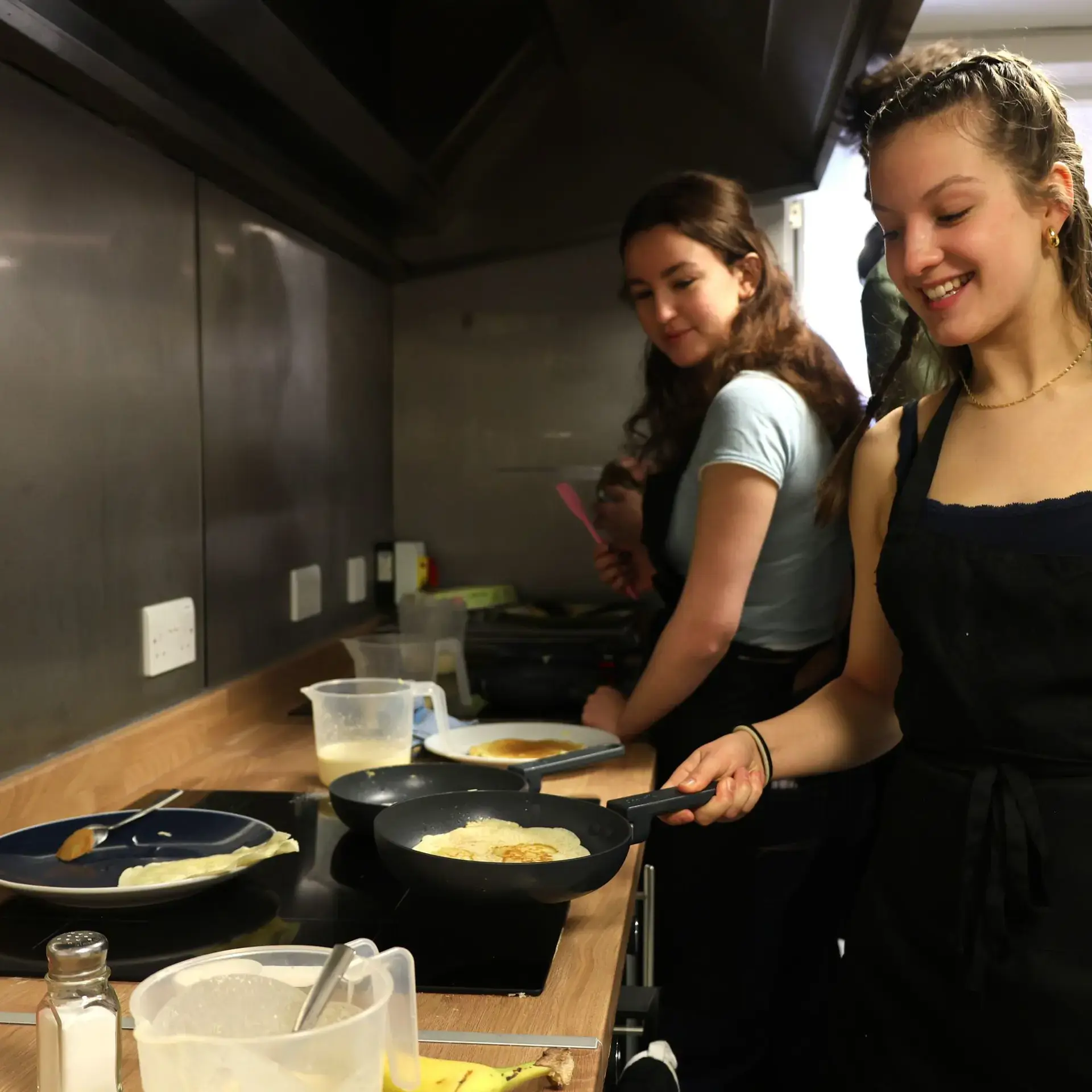 Student frying an egg