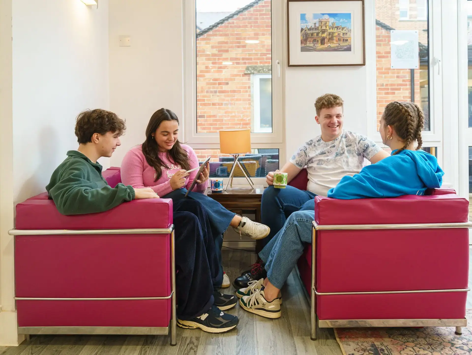 Group of students sitting on sofas having a conversation