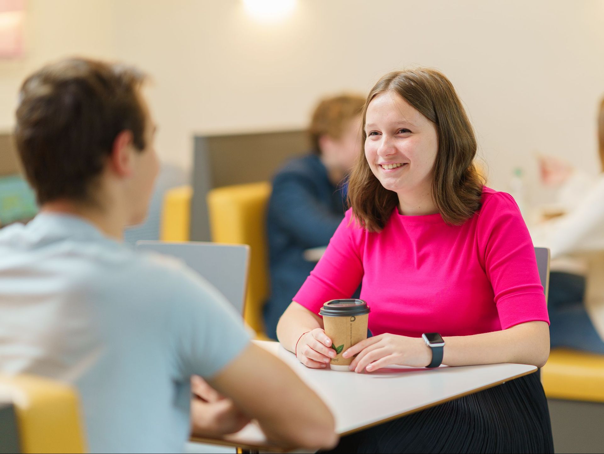 Two students having a conversation in the cafeteria