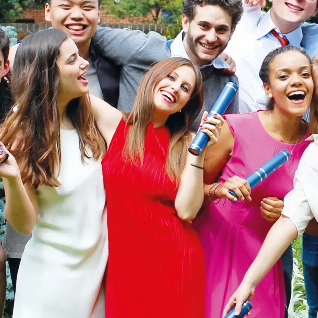 Female student smiling and holding graduation tube