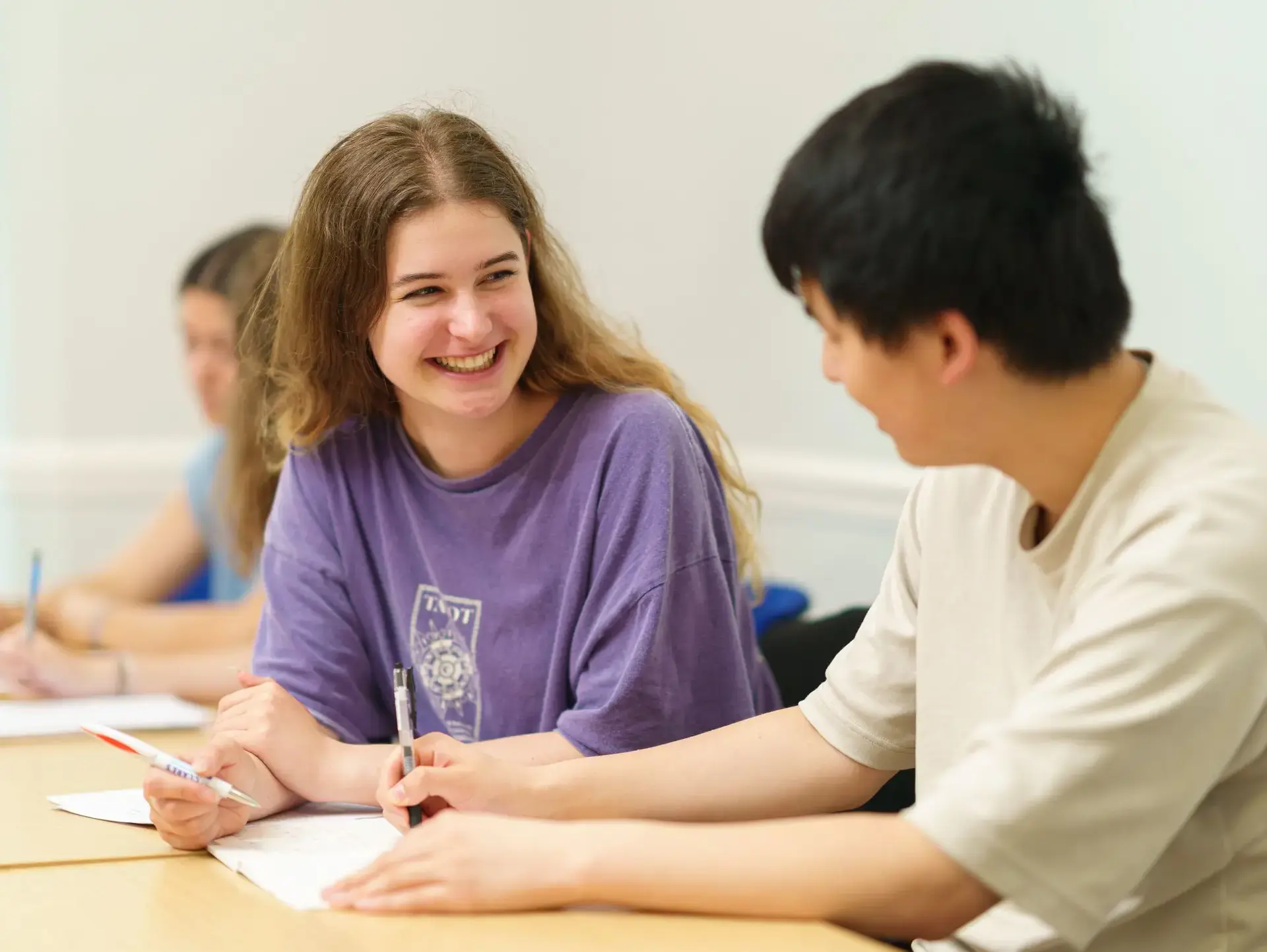 Students chatting at desk