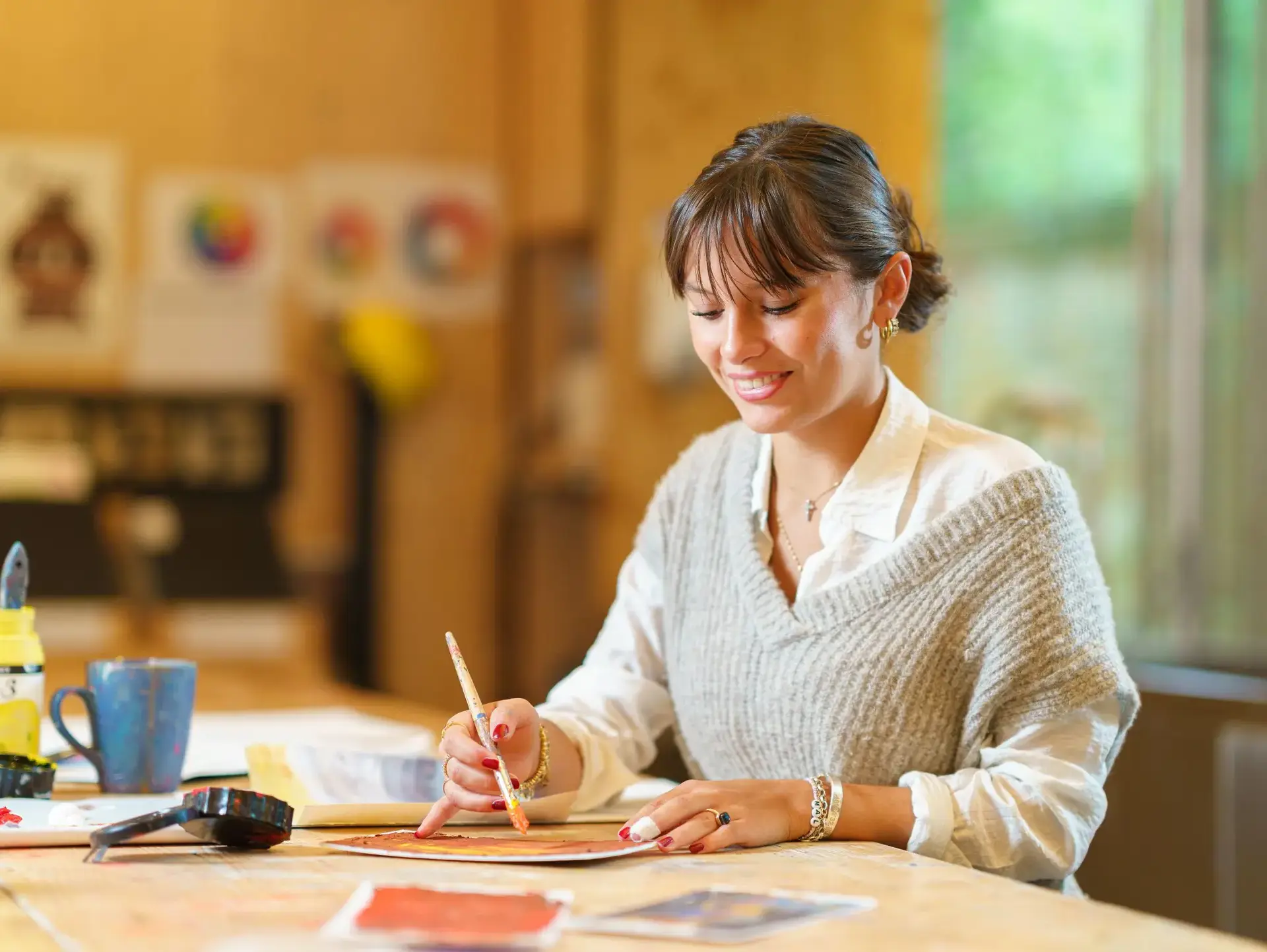Student painting at desk