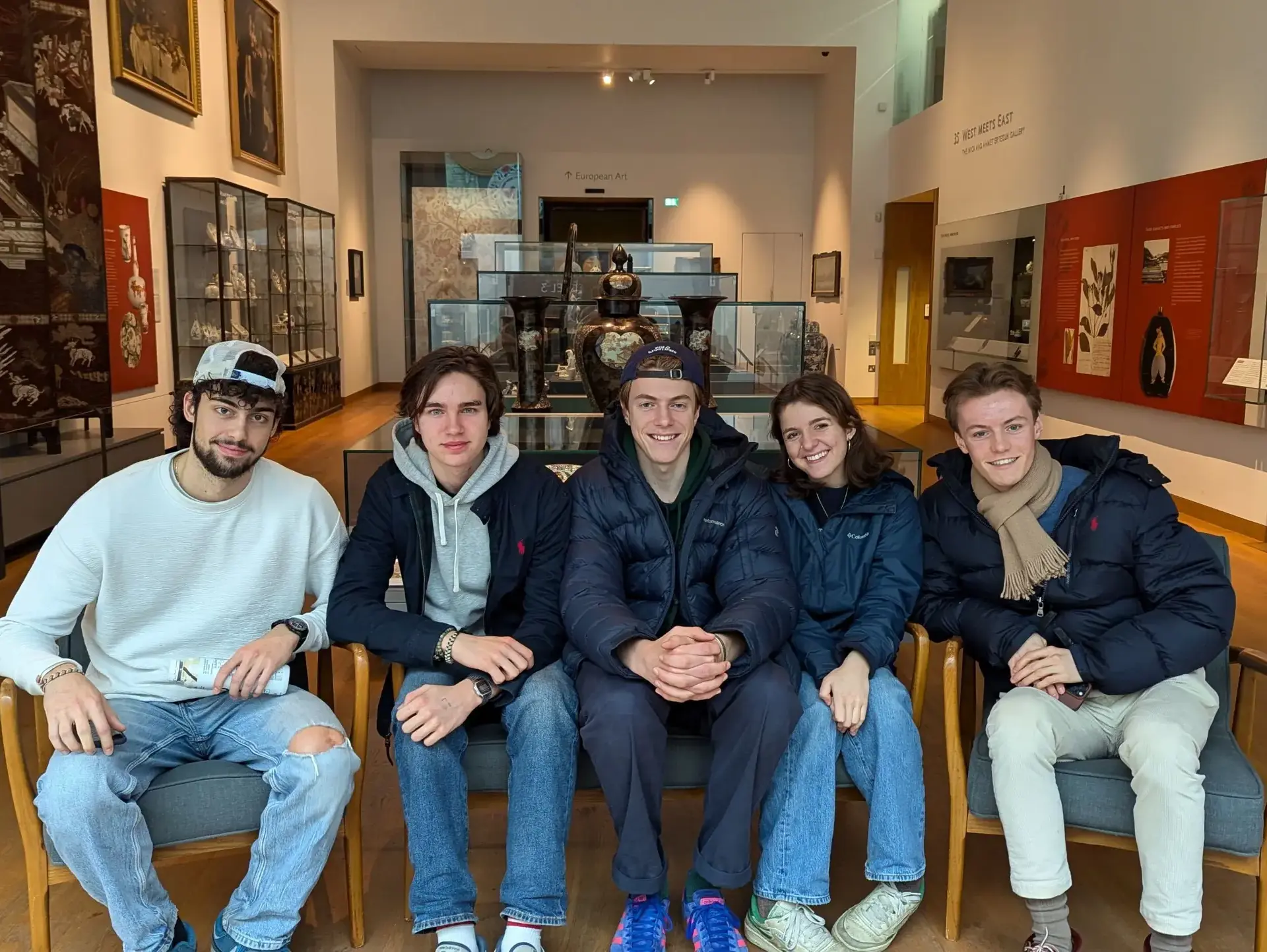 Group of students posing for photo in museum