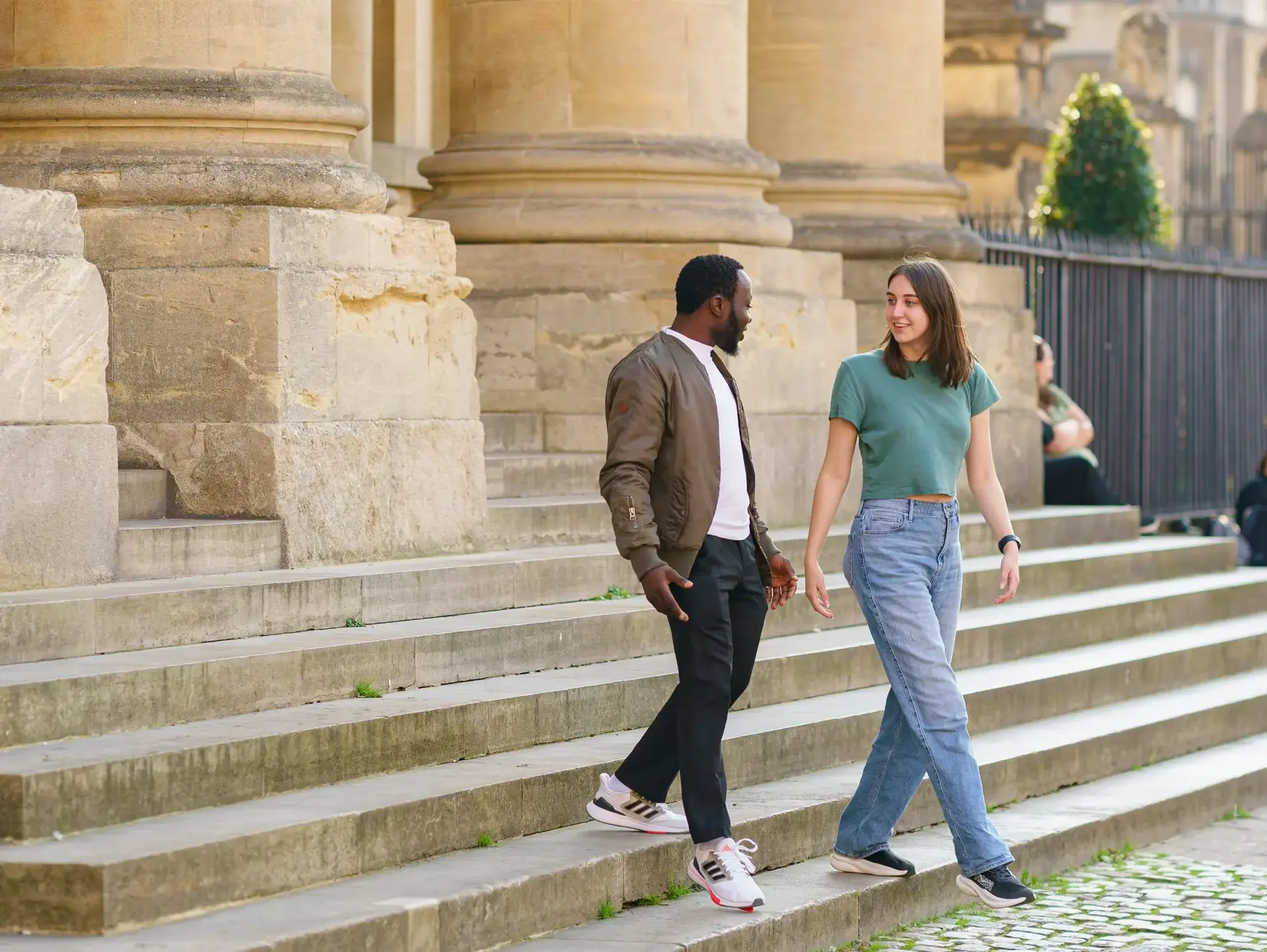 Students walking down steps outside building