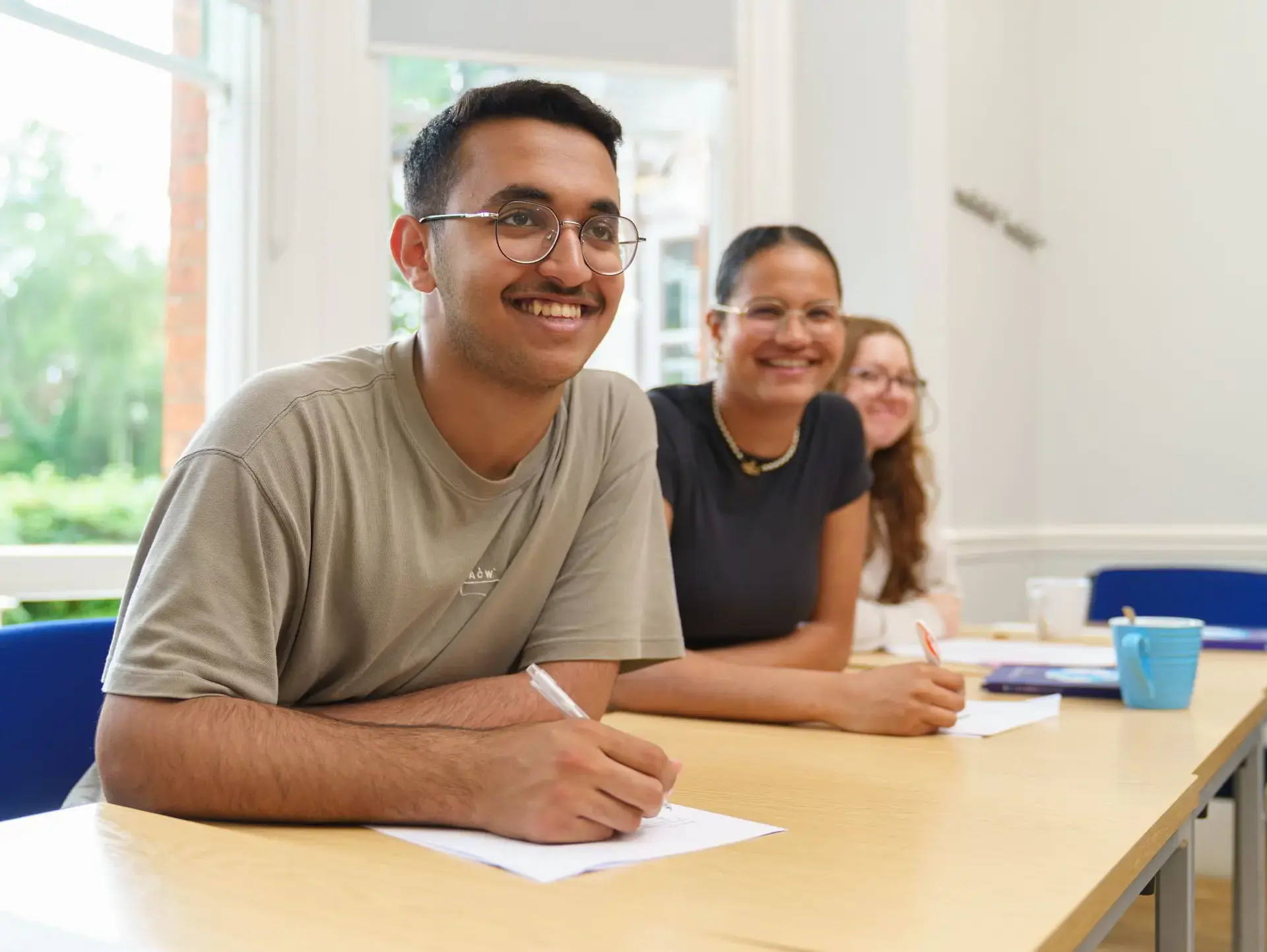 Students smiling up from their desks
