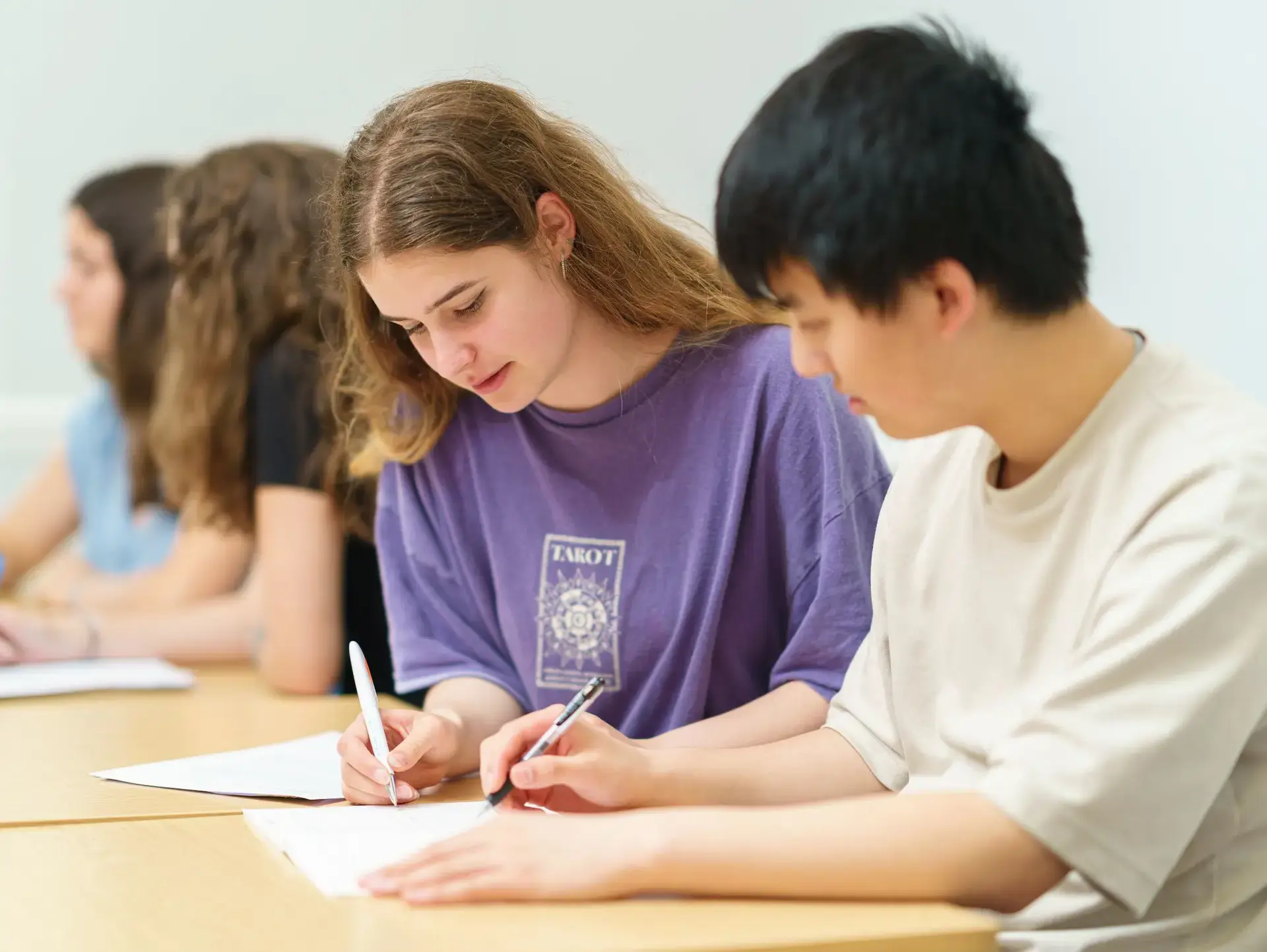 Students writing on notepads