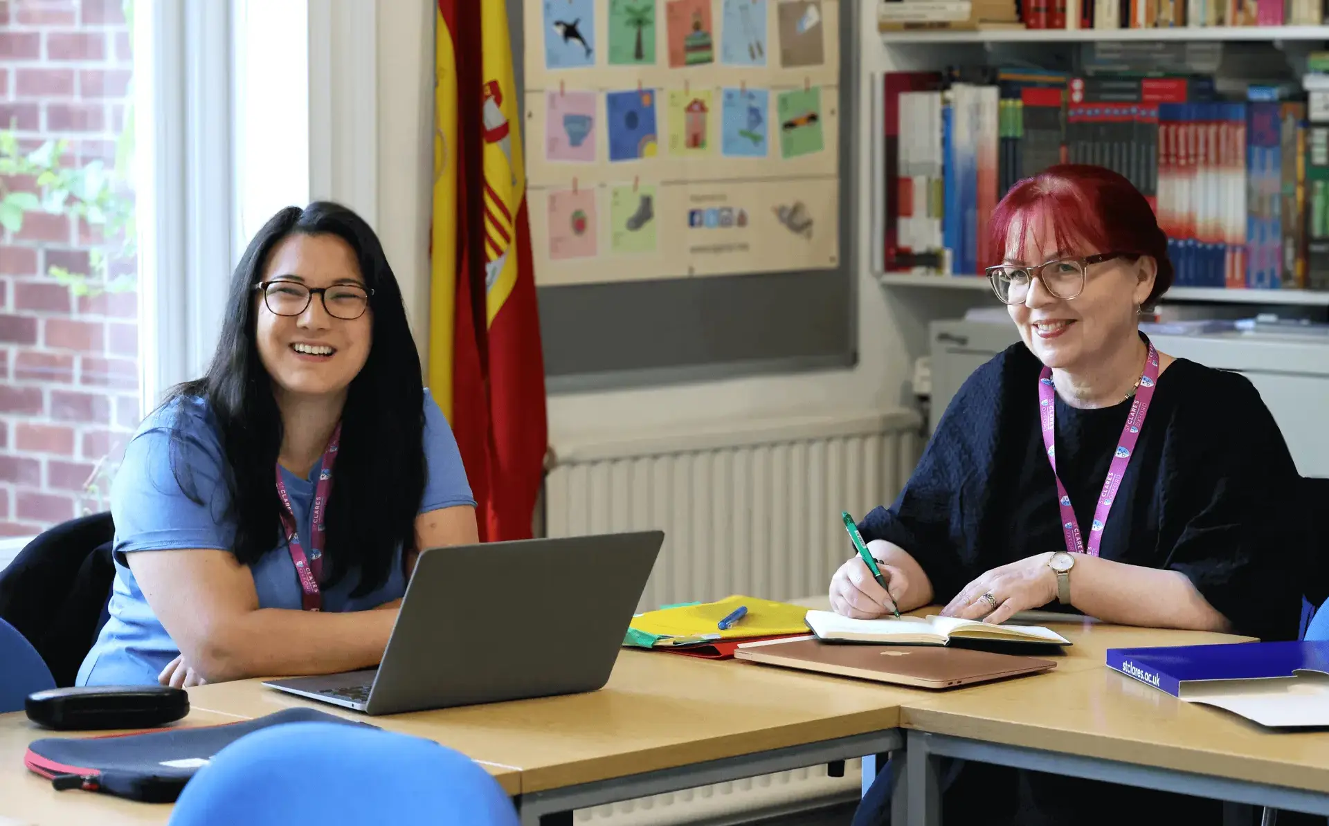 Teacher smiling up from their work during seminar