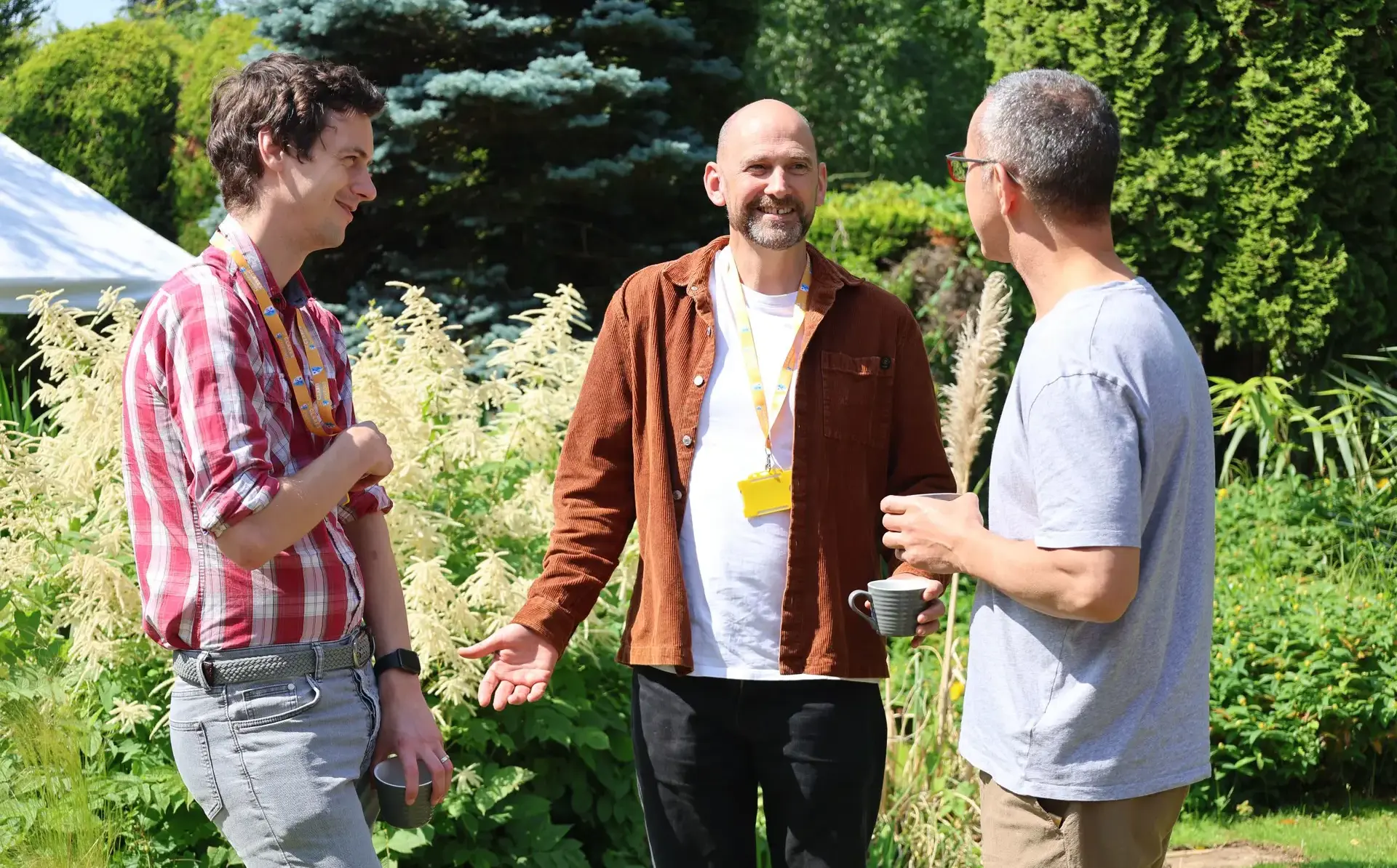Three teachers chatting outside on a sunny day