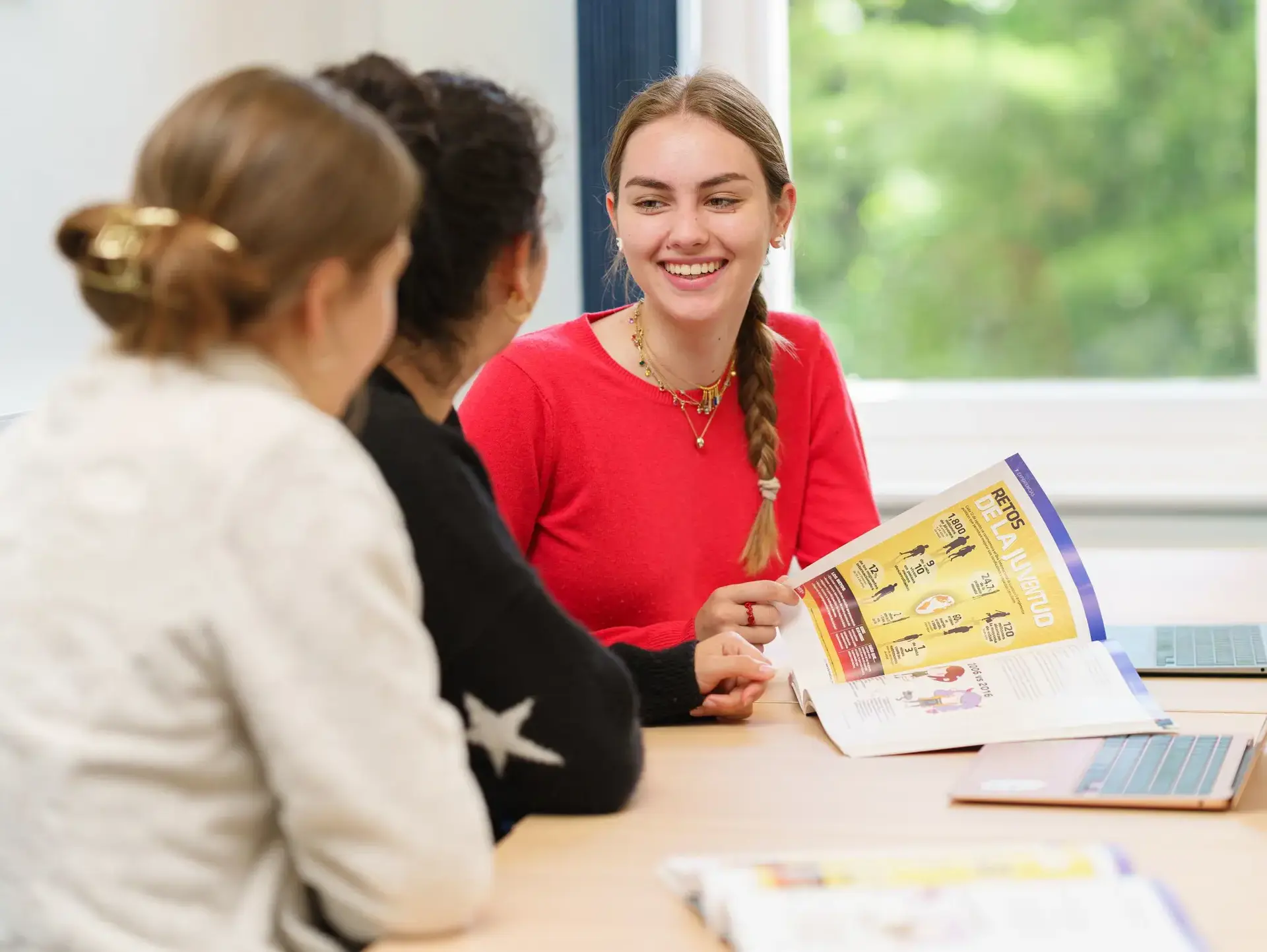 Students smiling across desk at each other