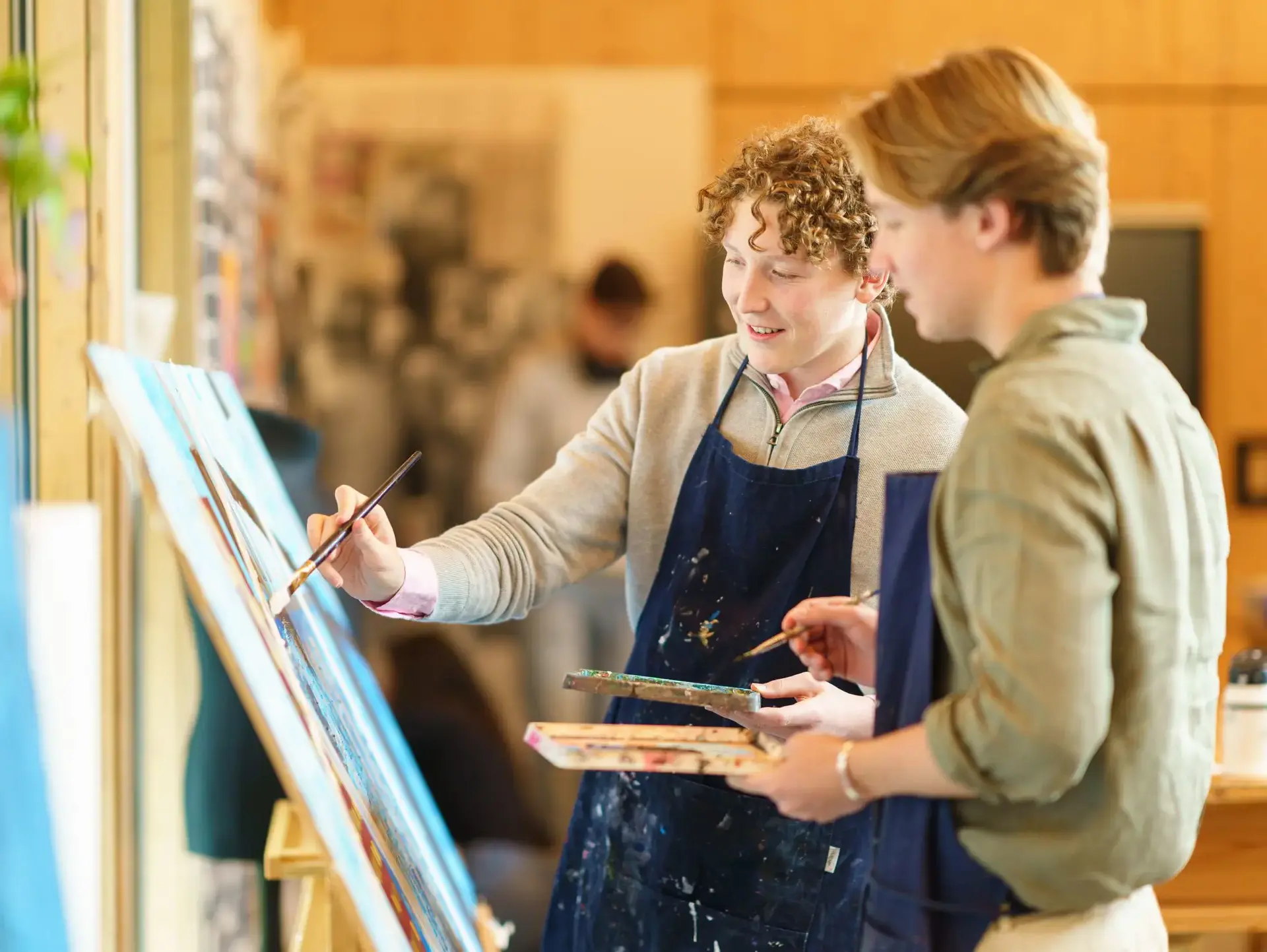 Students painting at easel