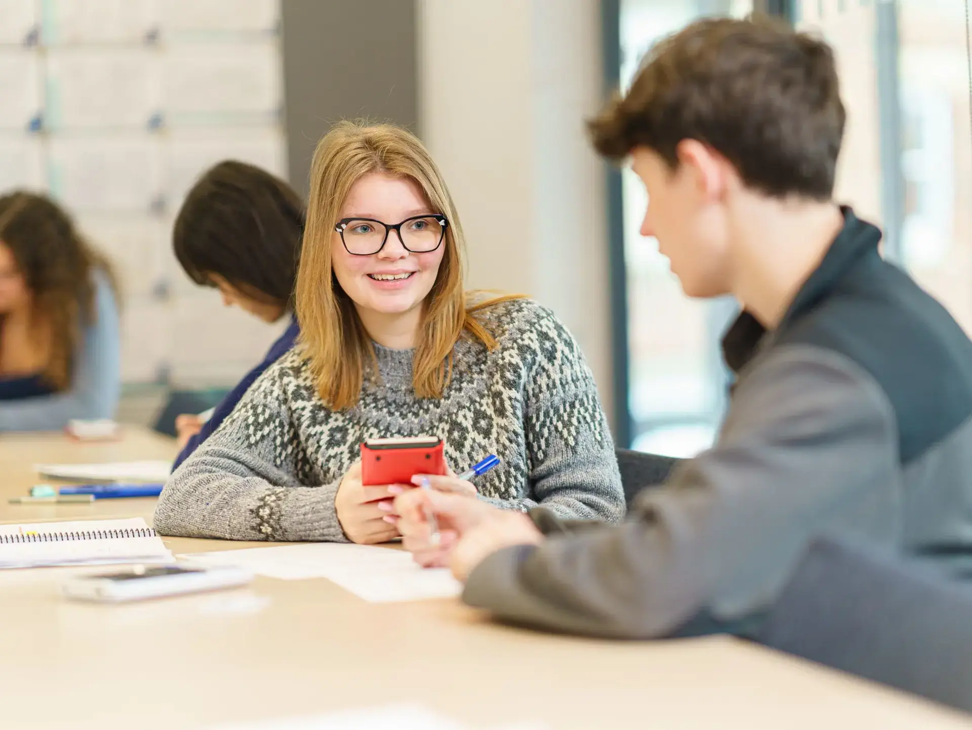 Students chatting at desk