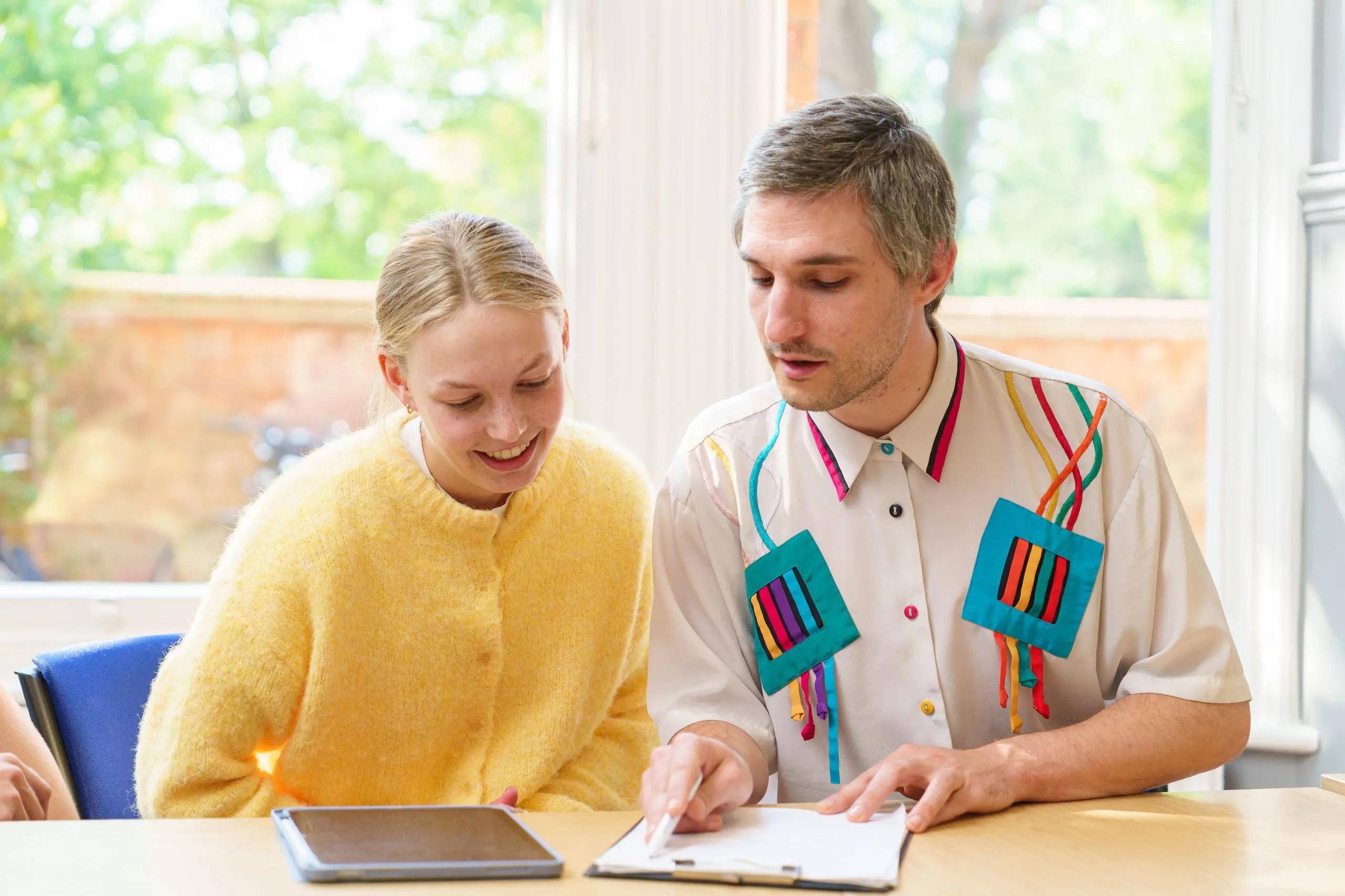 Two people examining clipboard