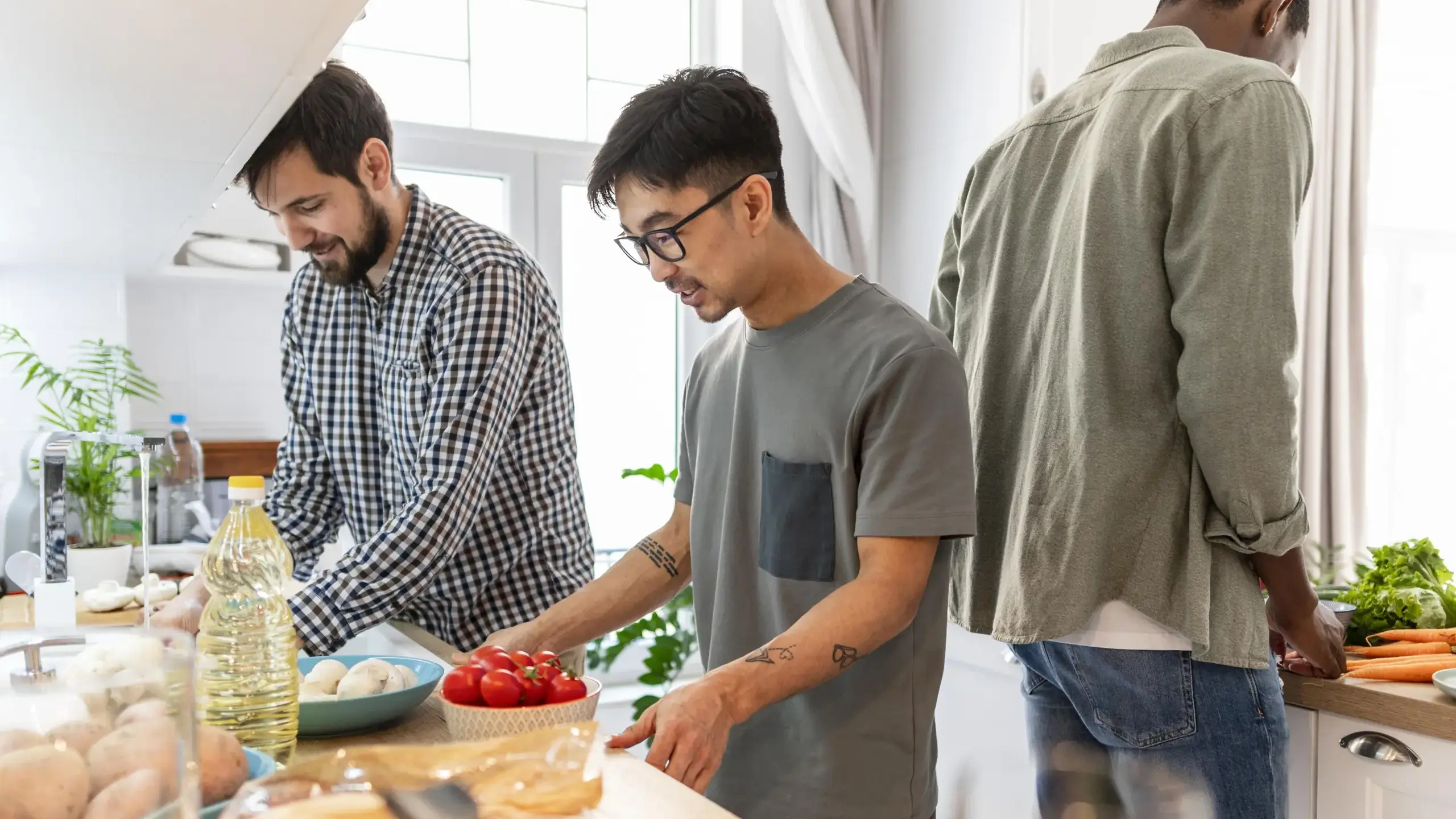 Male students cooking in homestay kitchen