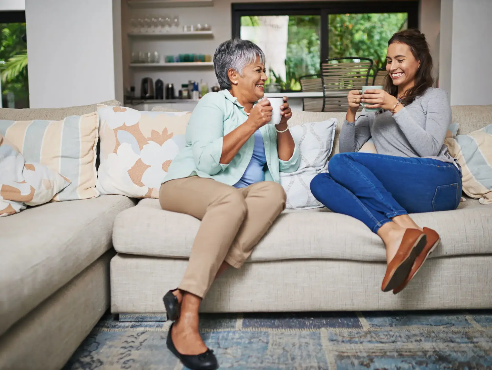 Student sitting on sofa with homestay adult