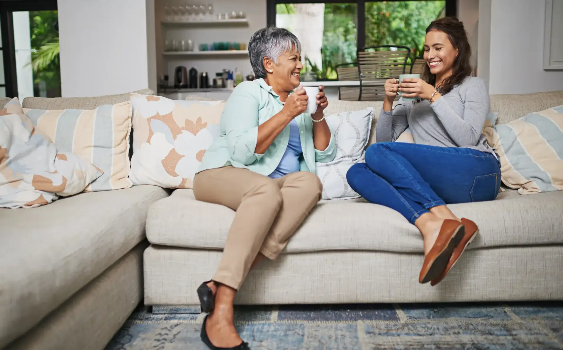 Student and homestay provider chatting on sofa