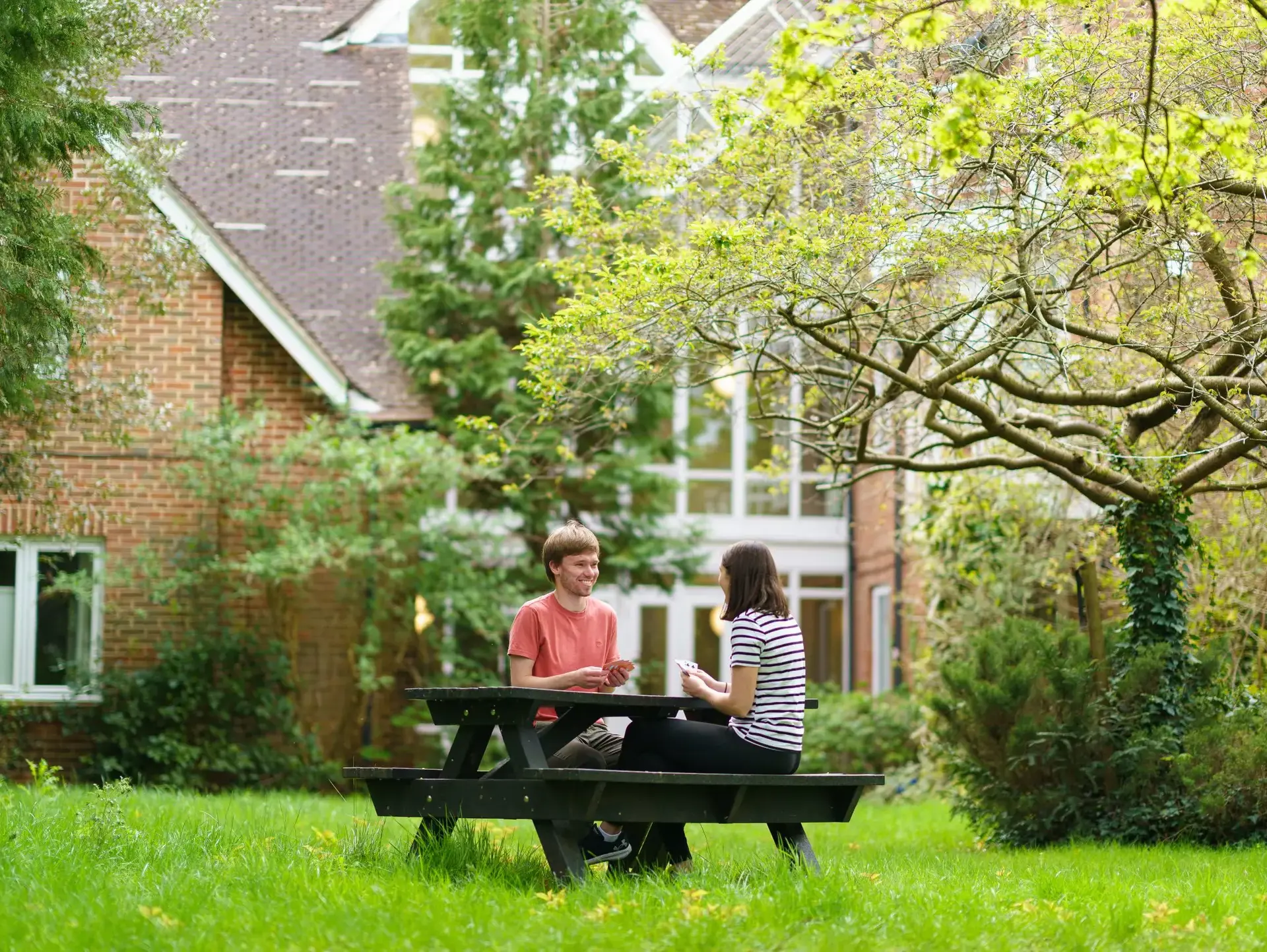 Two students sitting at a picnic table