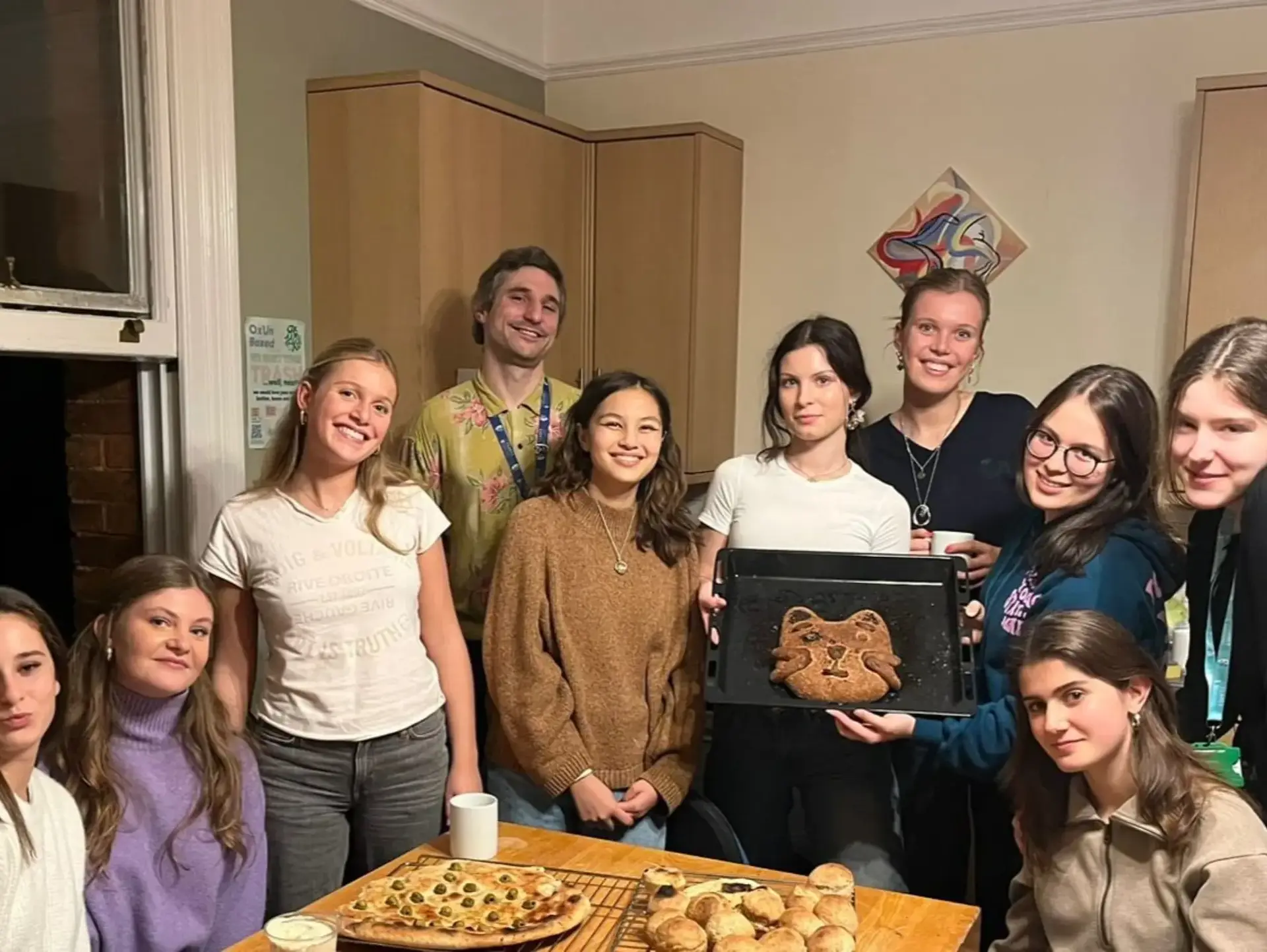Students posing for group photo with handbaked goods