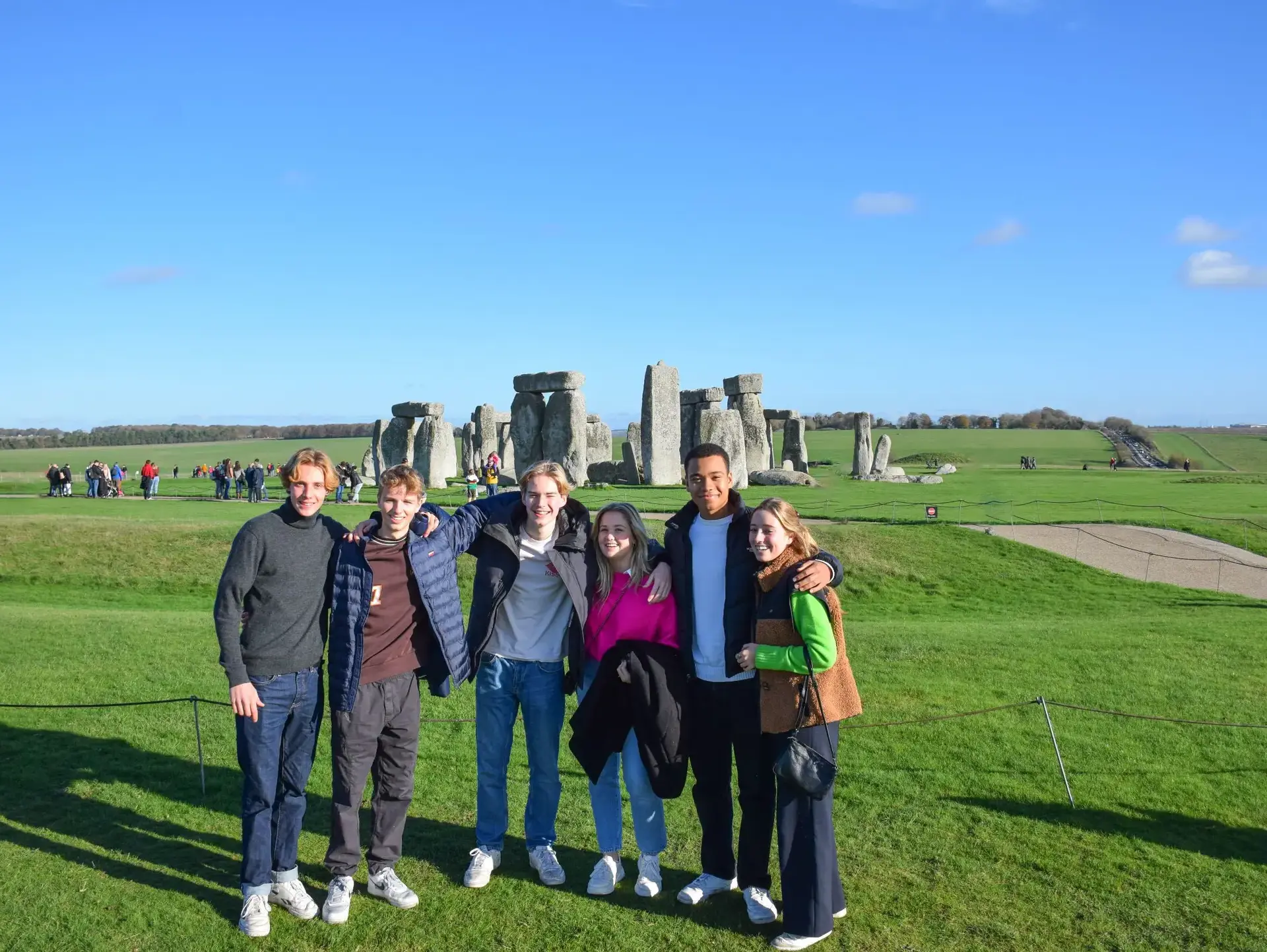 Students posing in front of Stonehenge