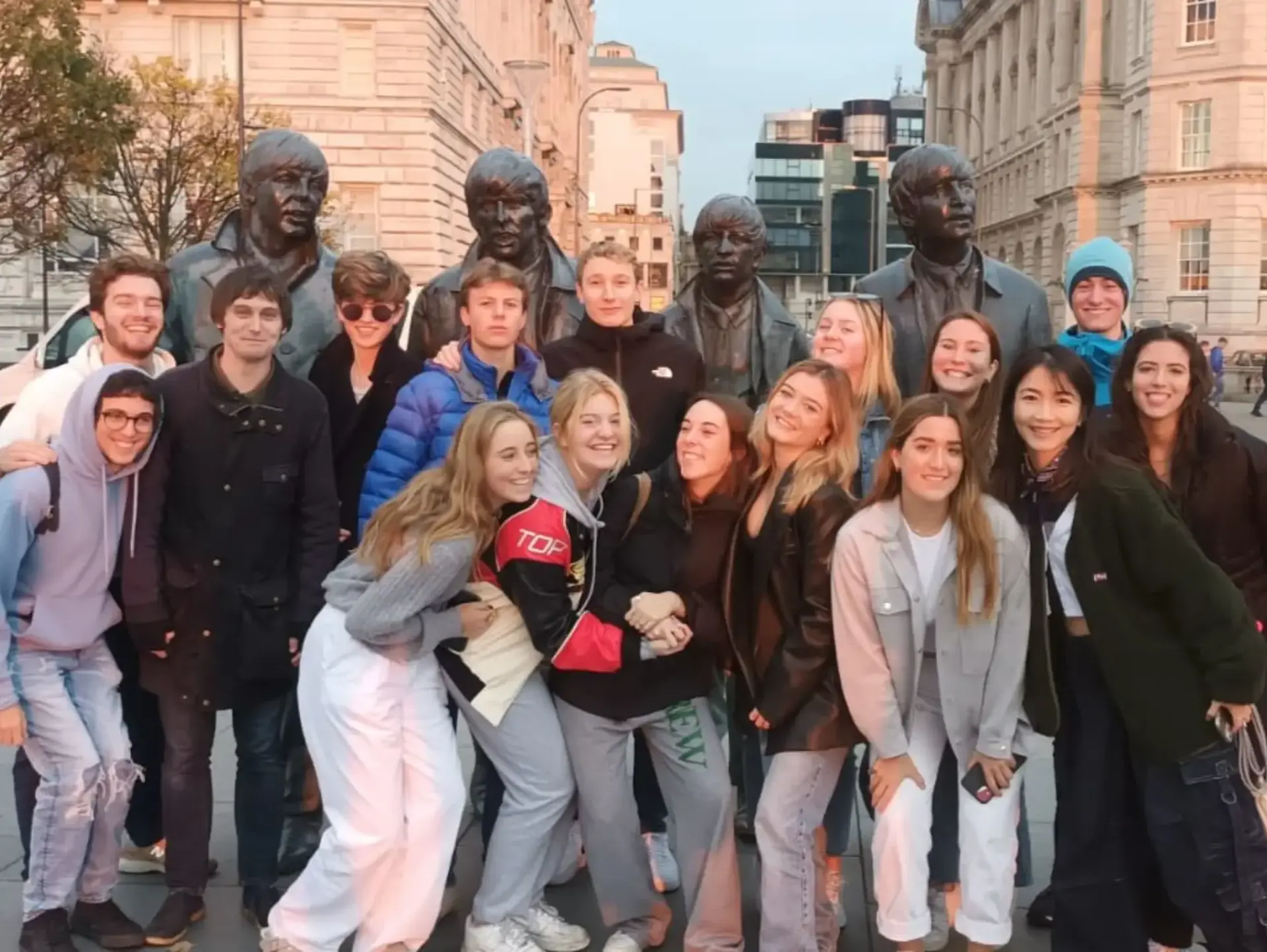 Students posing for group photo on street in Bath