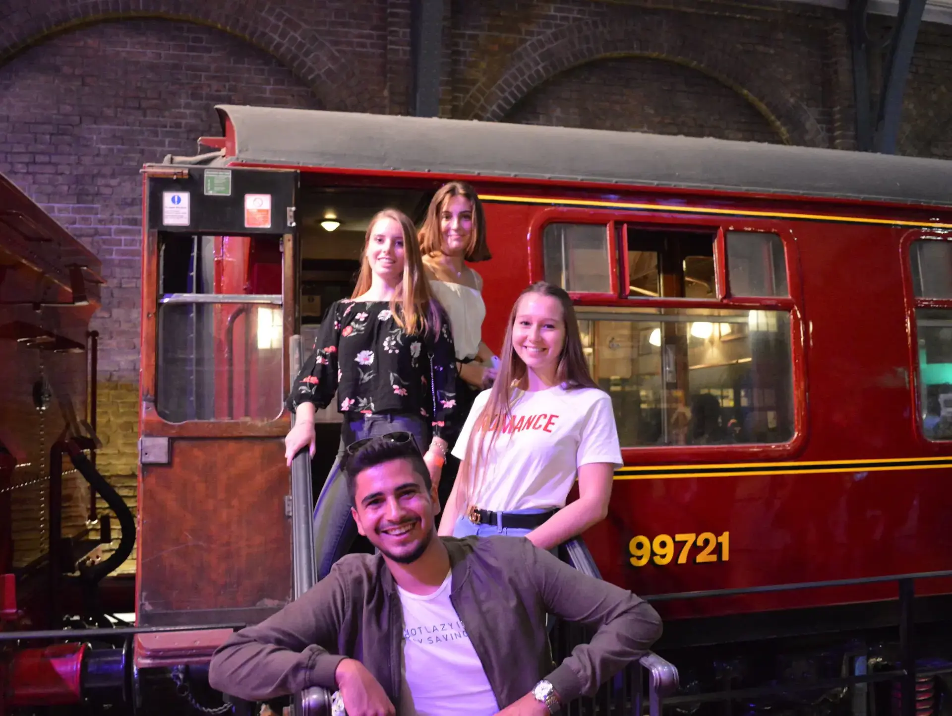 Students posing in front of old train car