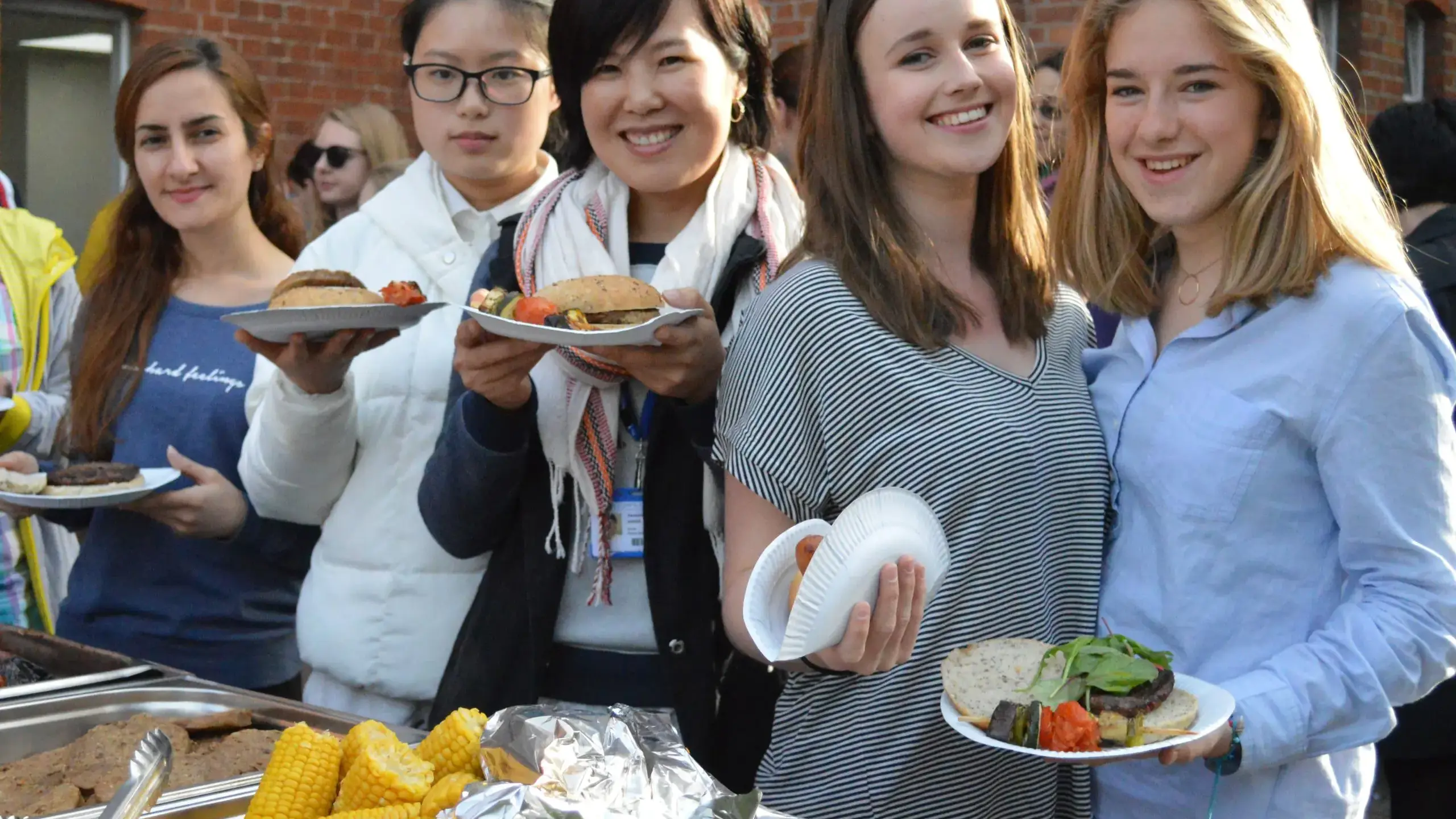 Students holding barbecue food
