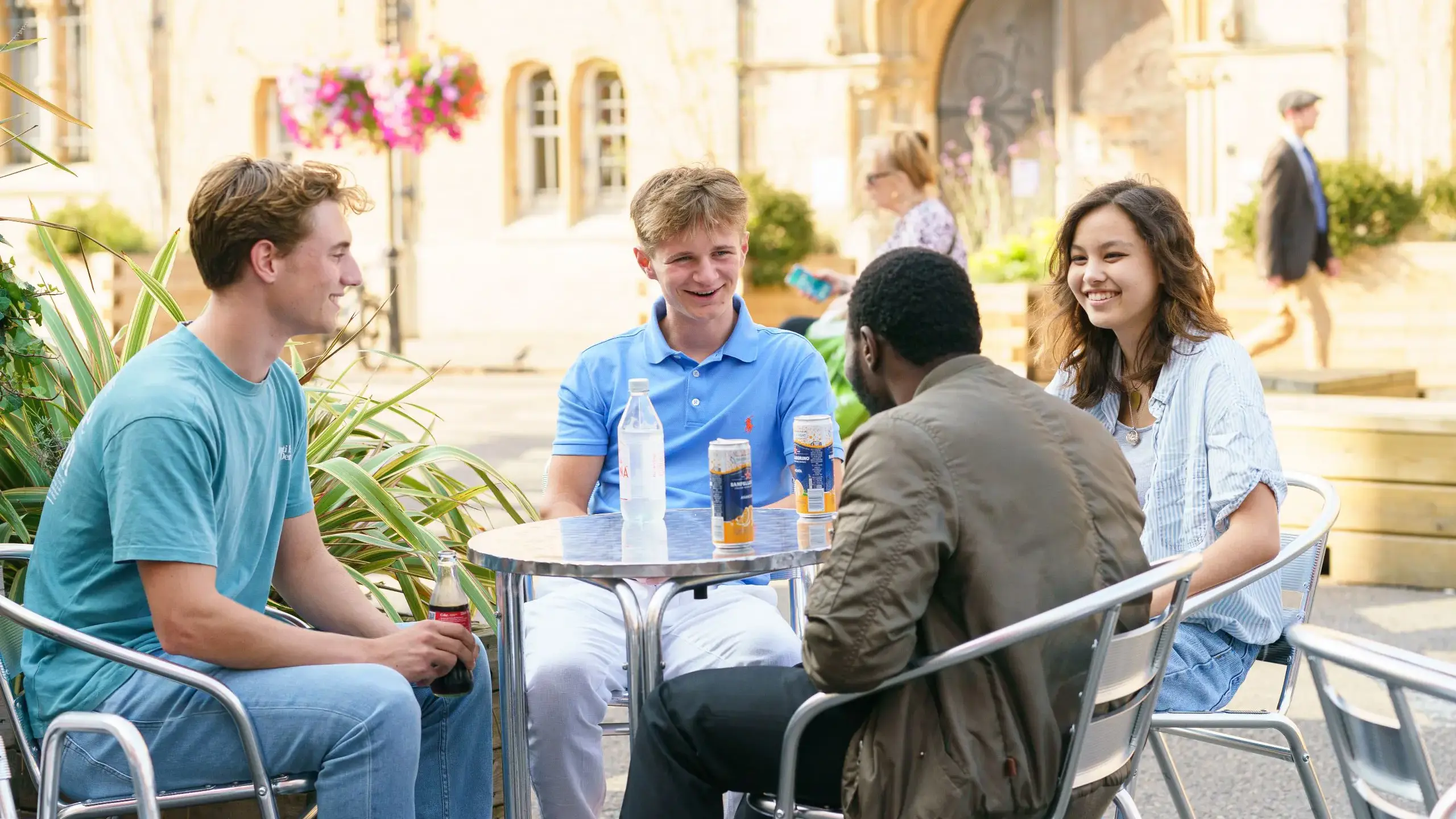 Students sitting at outdoor table chatting