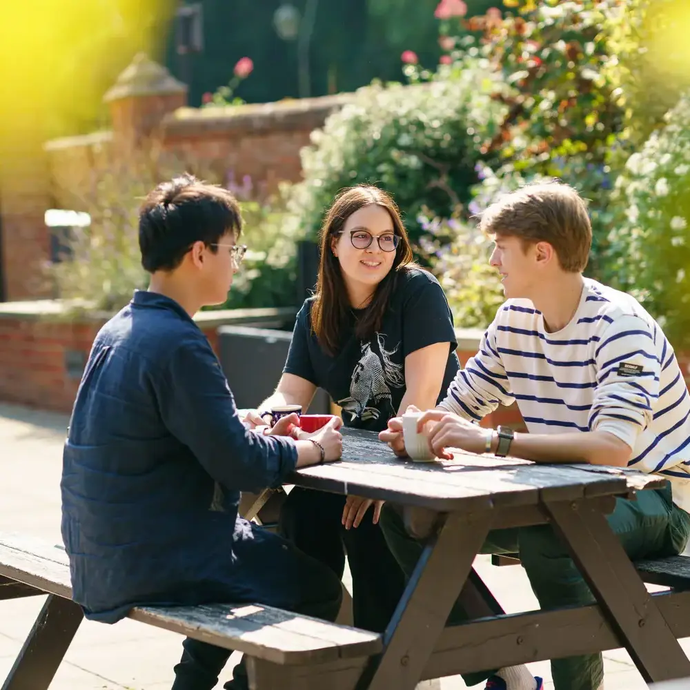 IC students sat at bench chatting