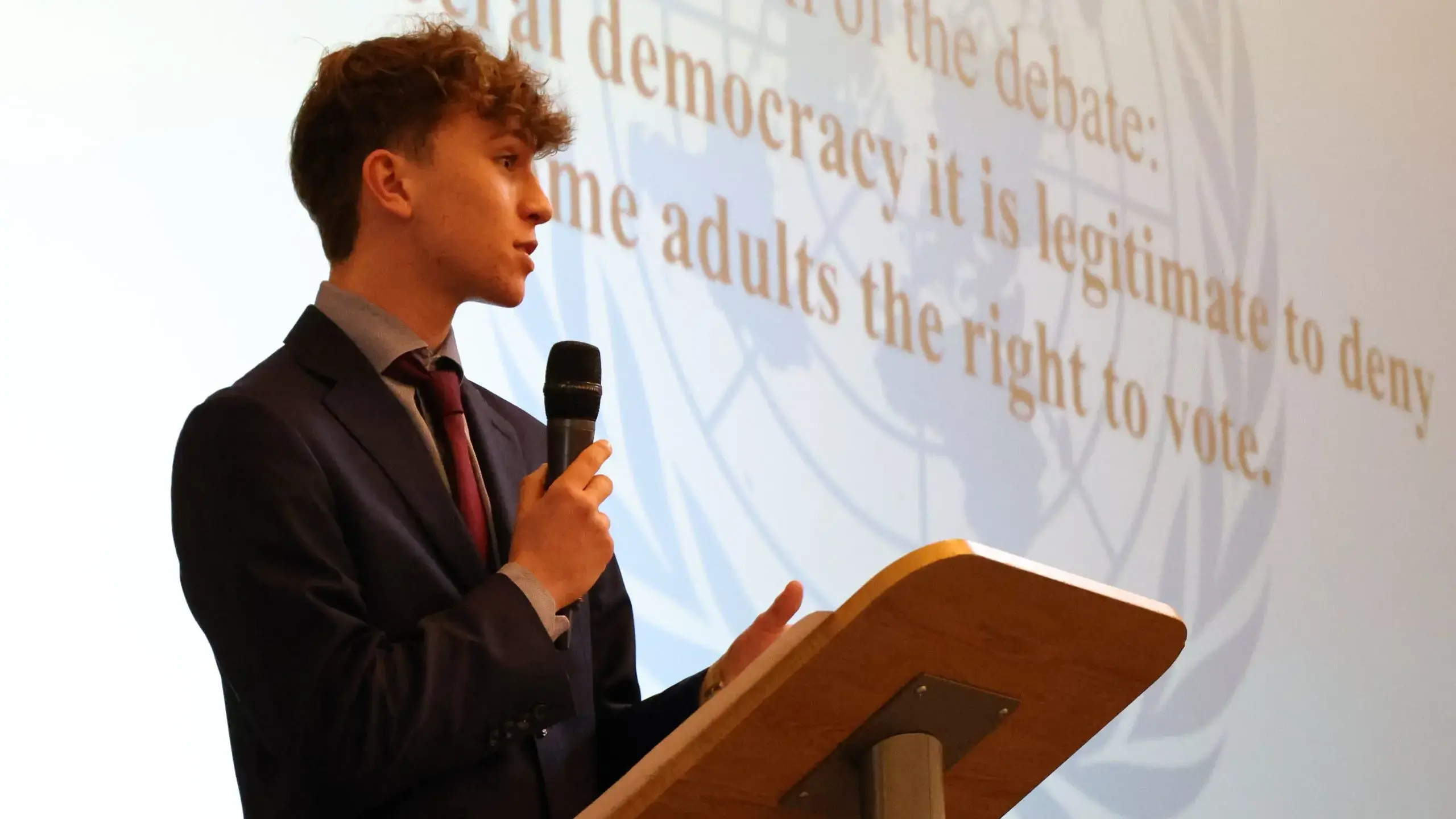 Student speaking behind lecturn