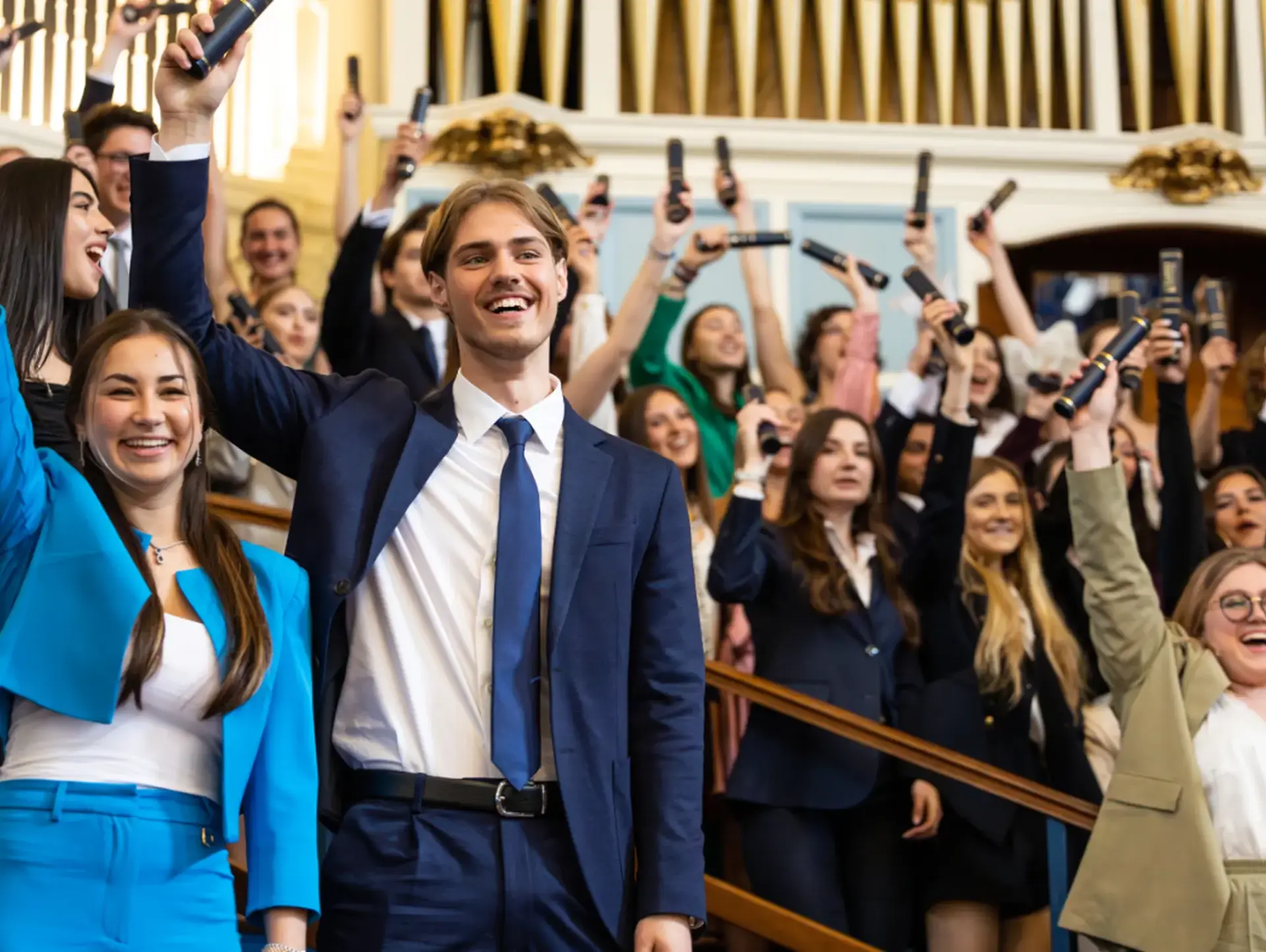 Students holding up diplomas