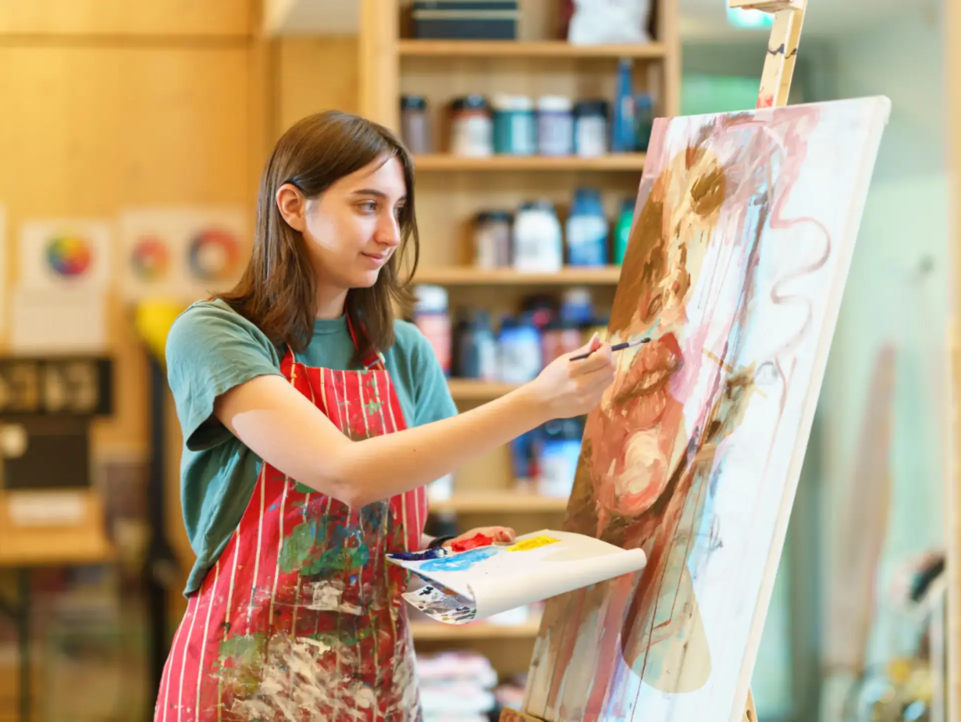 Art student painting on easel