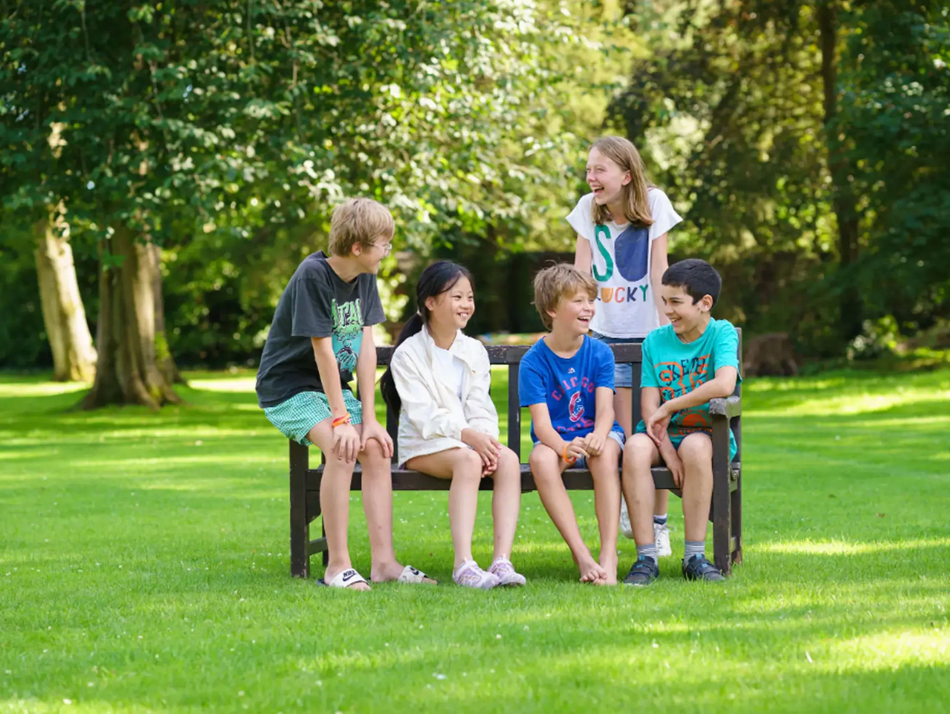 Students sitting on bench outdoors