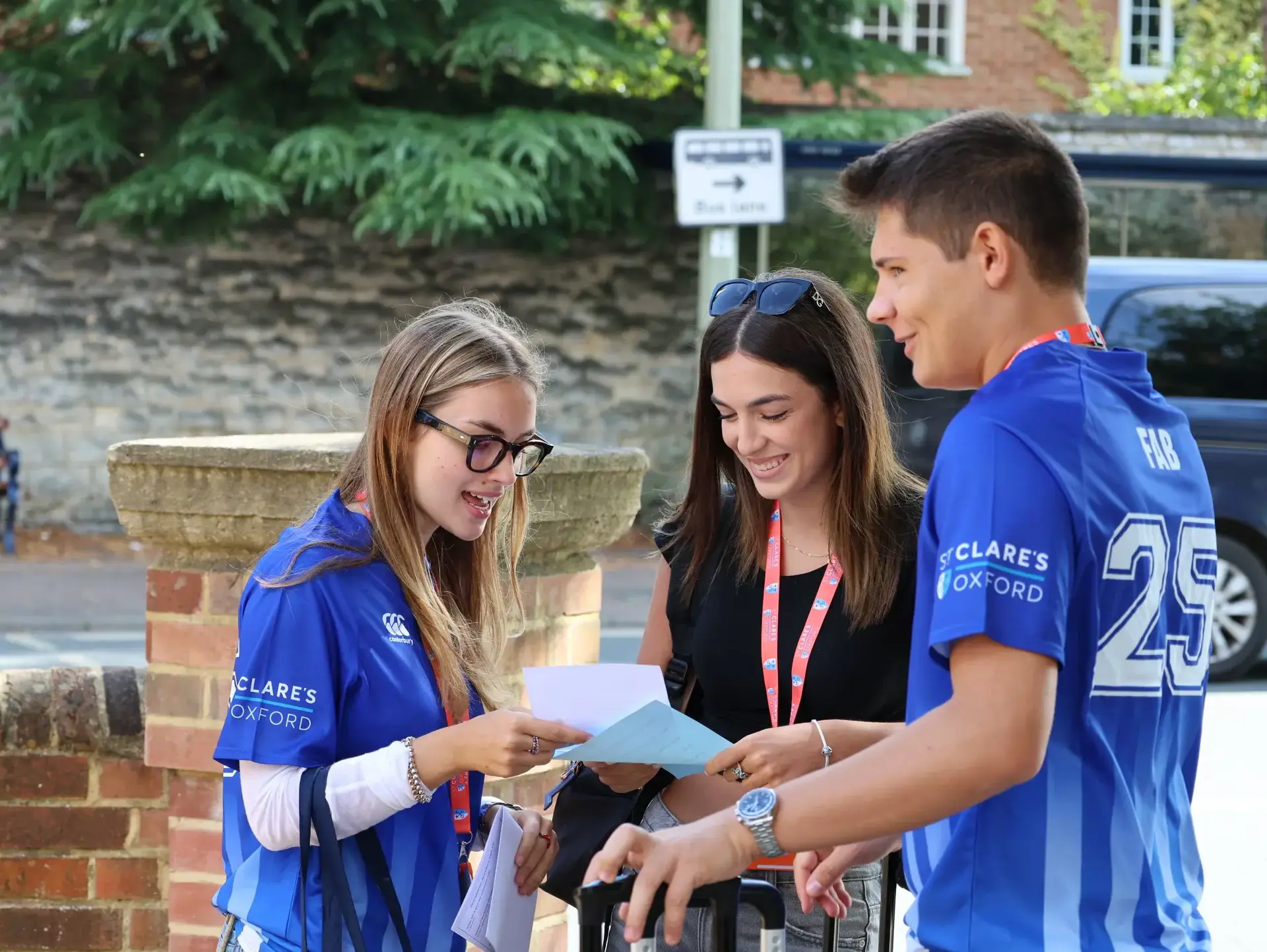 Three students chatting outside