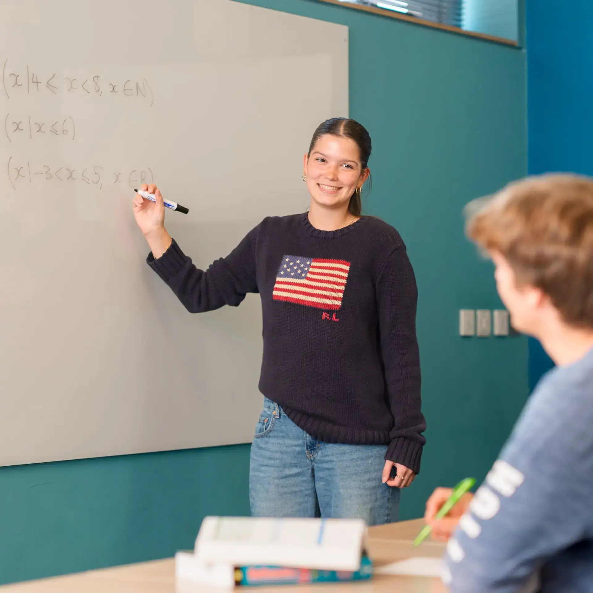 Student writing on whiteboard