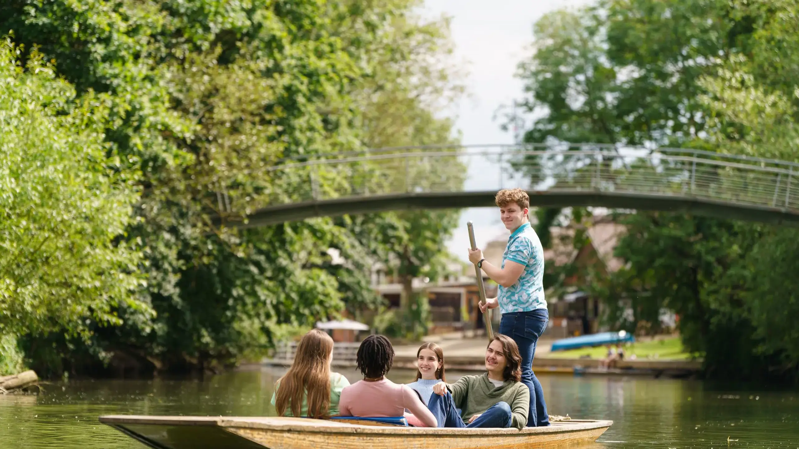 Students rowing on river 
