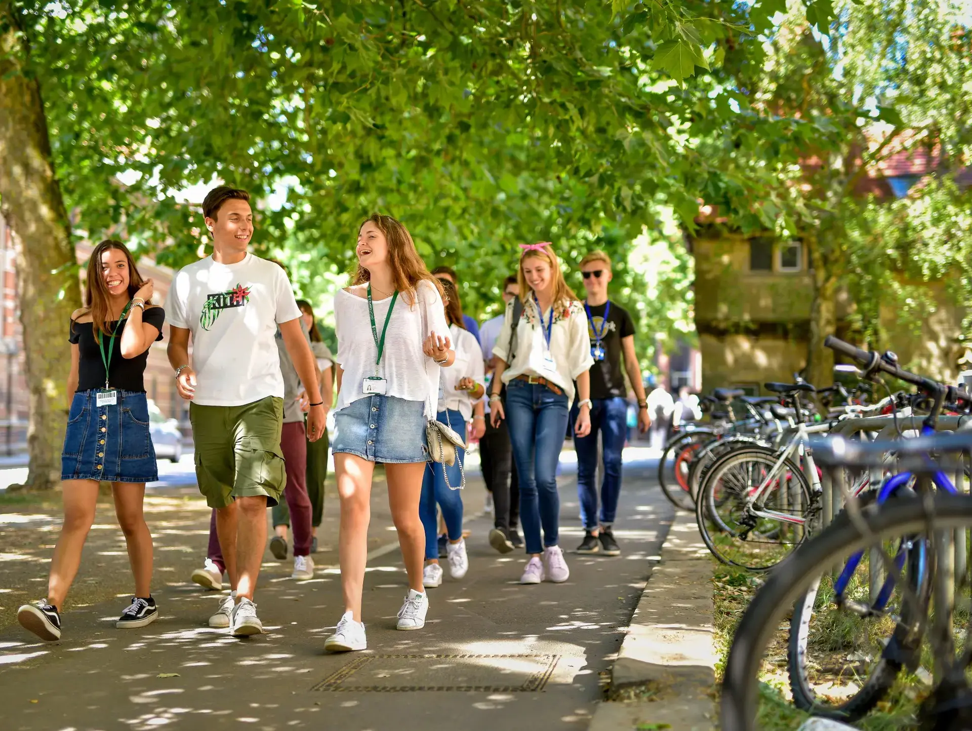 Students walking through Oxford together, wearing lanyards