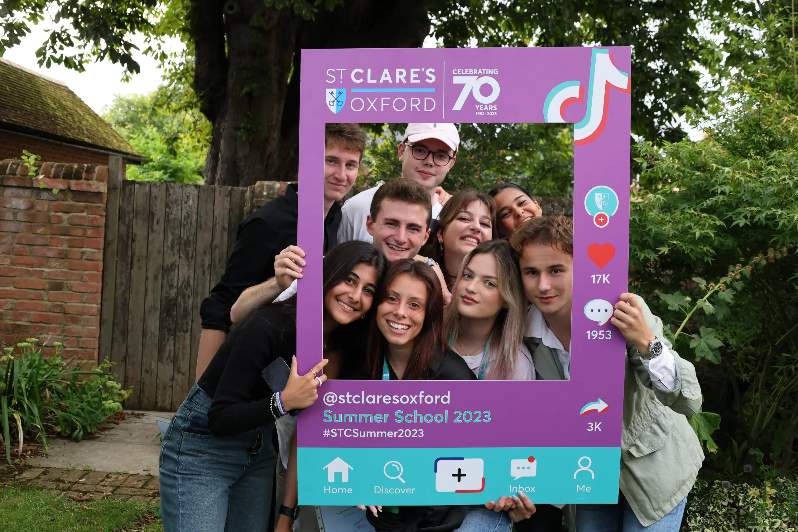 Students posing in card frame 